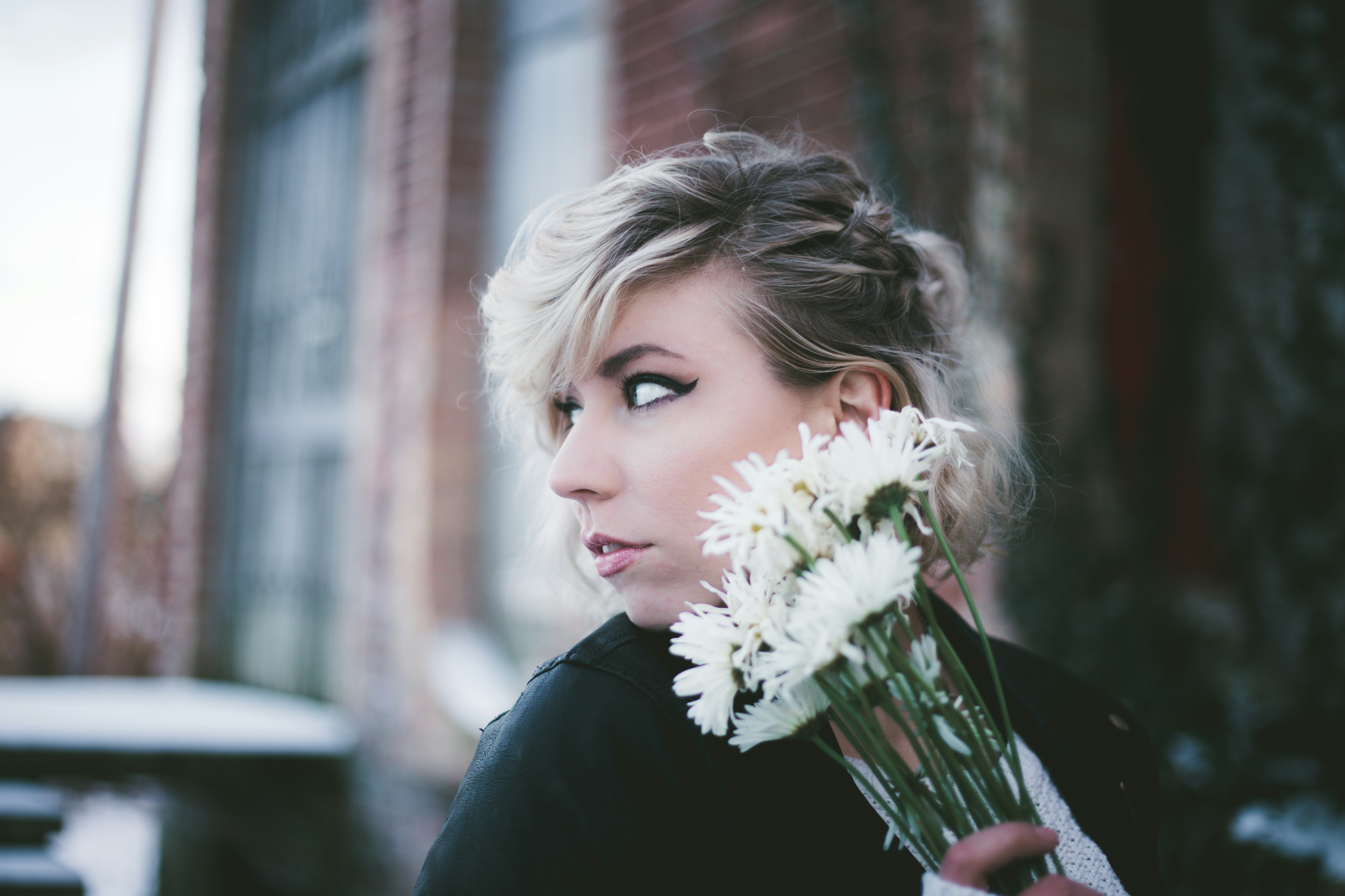 Woman Holding White Daisies Outdoors