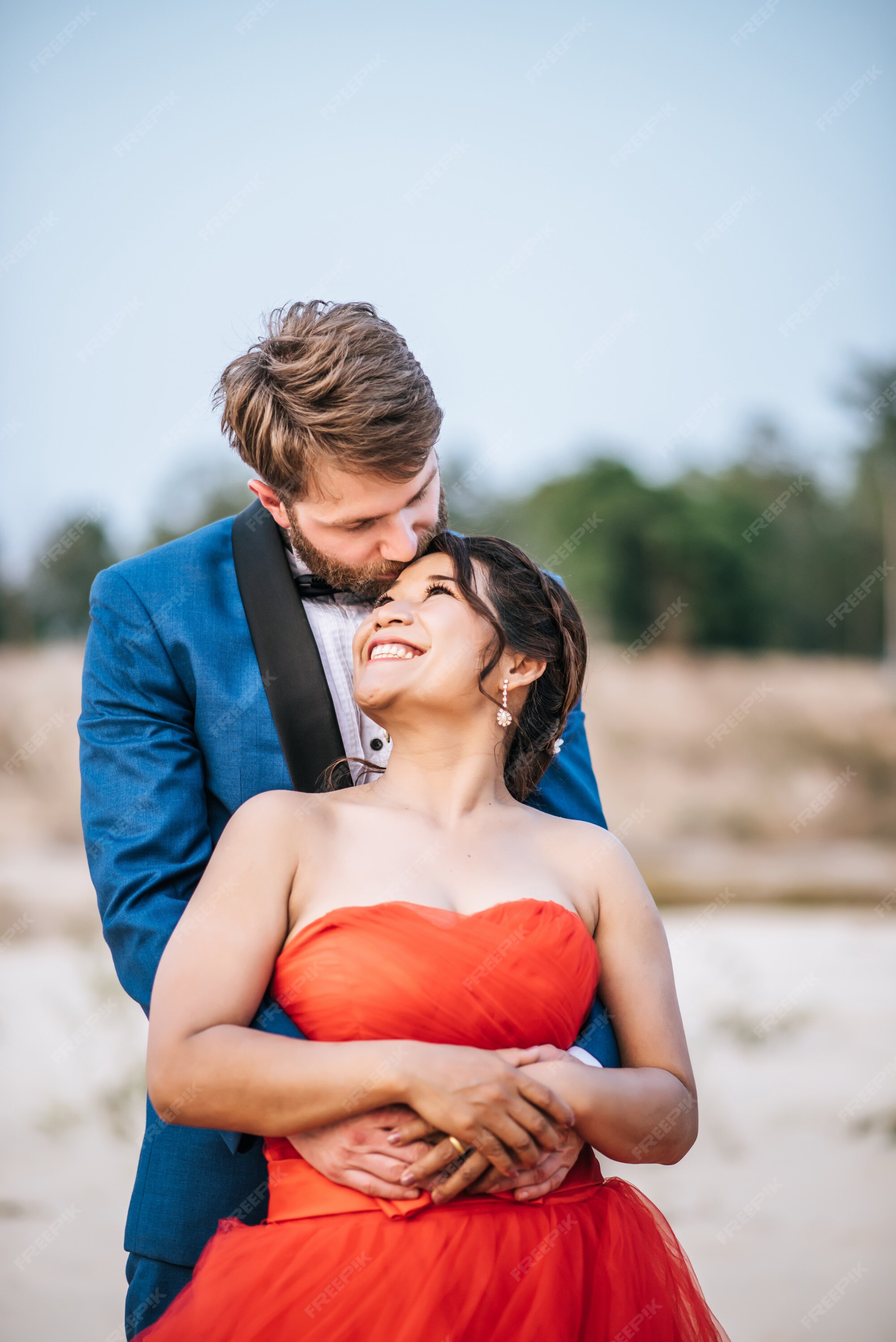 Engaged Couple Embracing On Beach