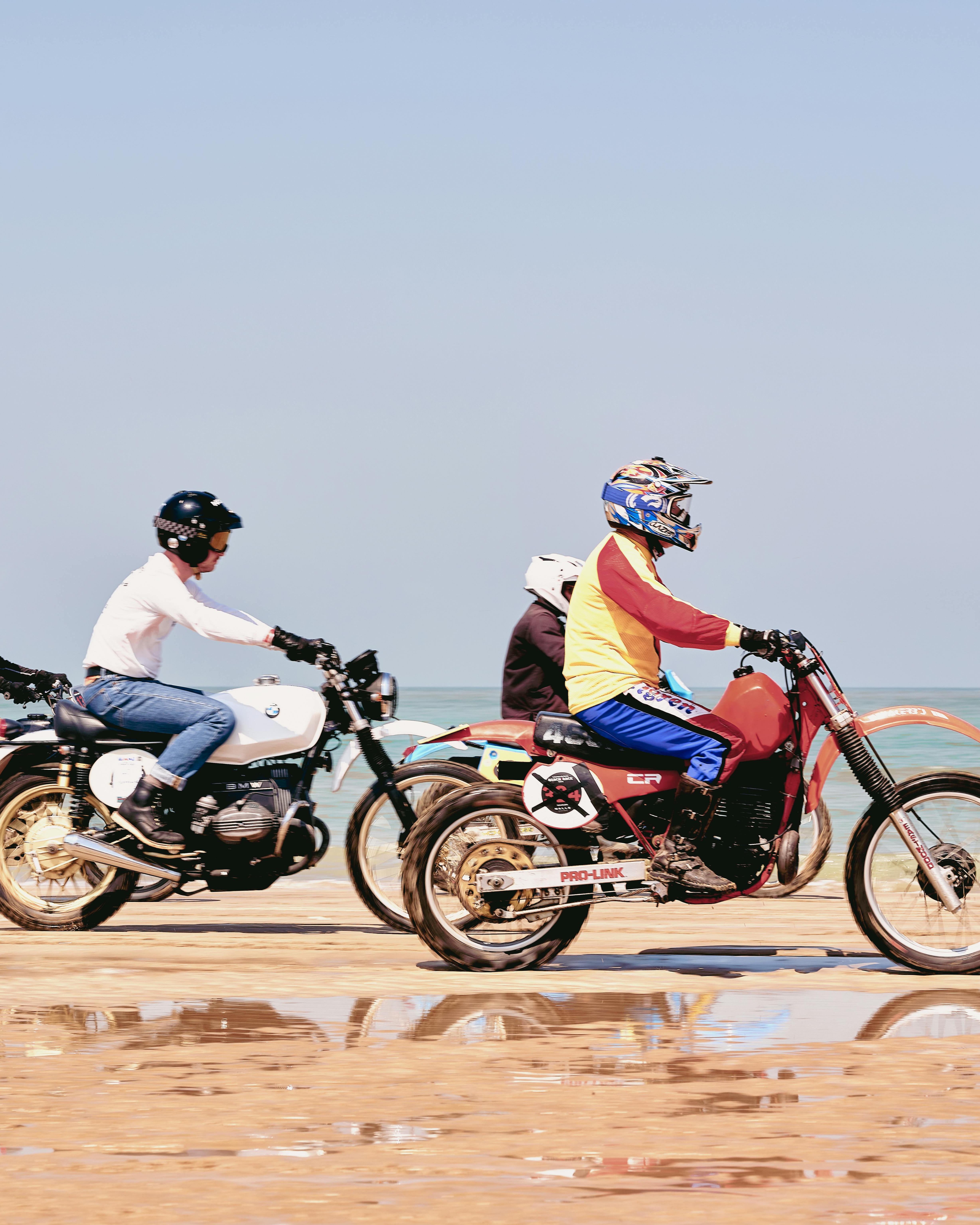 Three Motorcyclists Riding on Beach