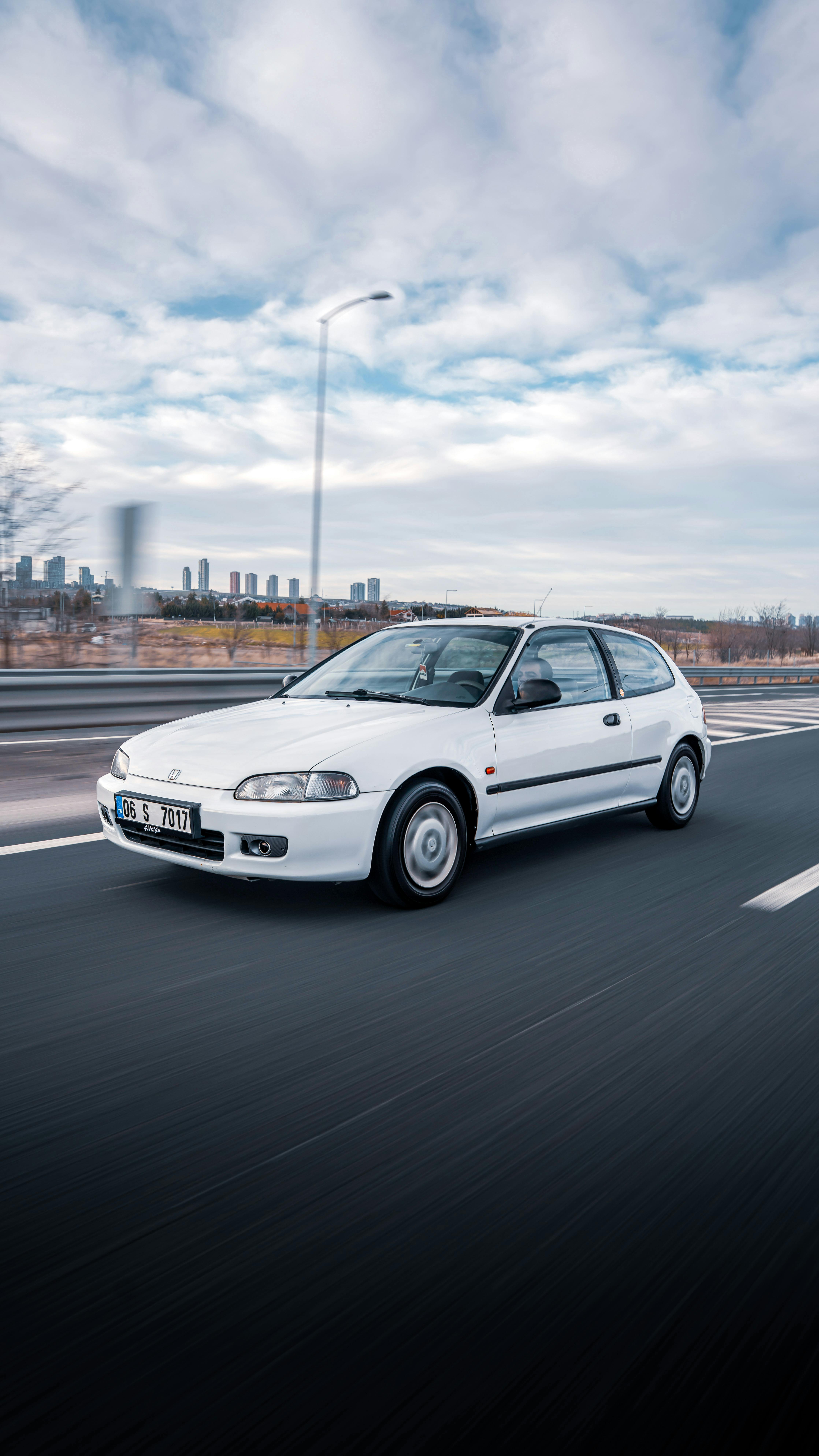 White Honda Civic Driving on Highway