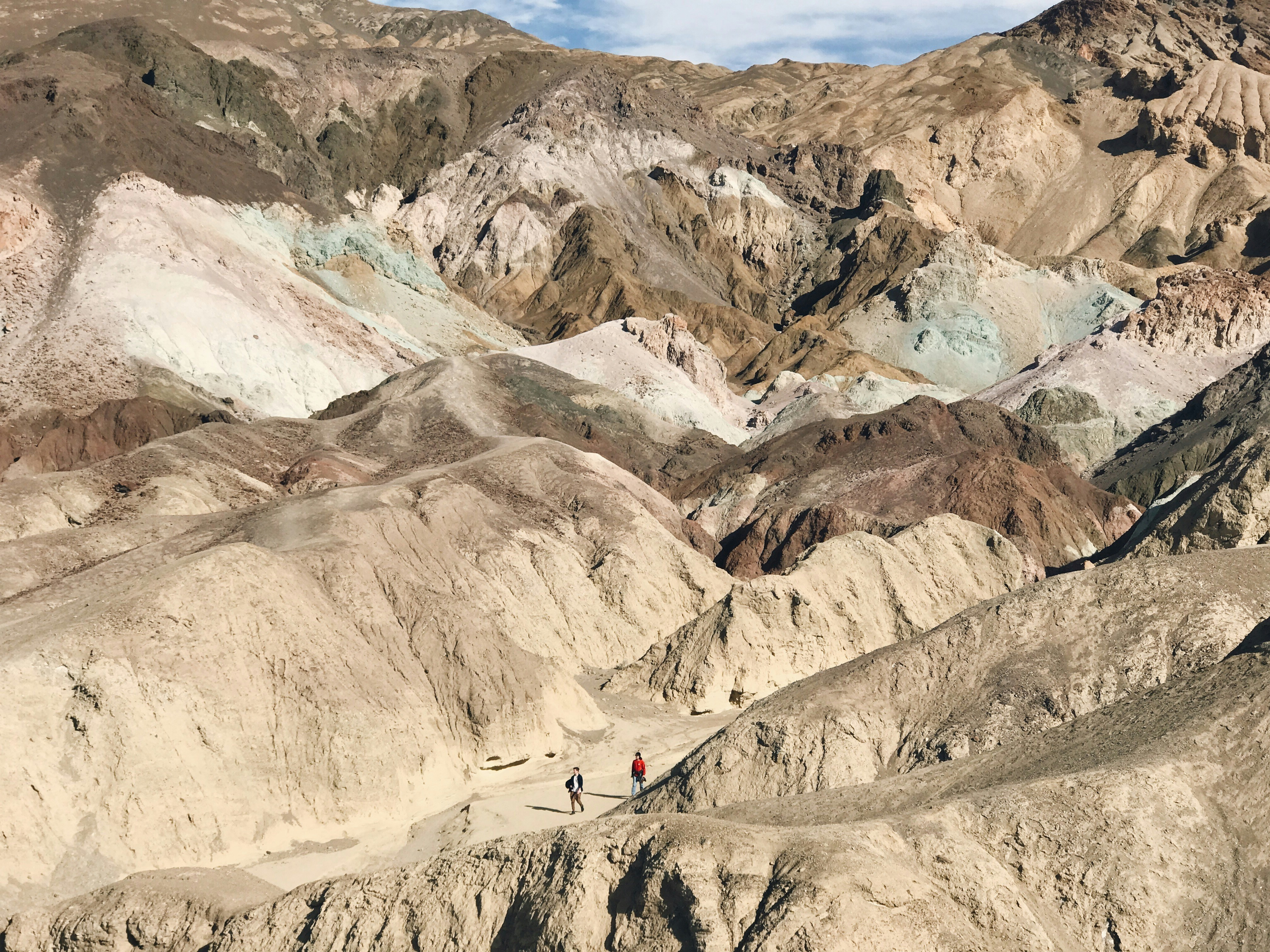 Hikers in Colorful Desert Badlands