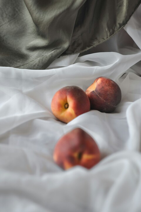 Three Peaches on Soft Fabric