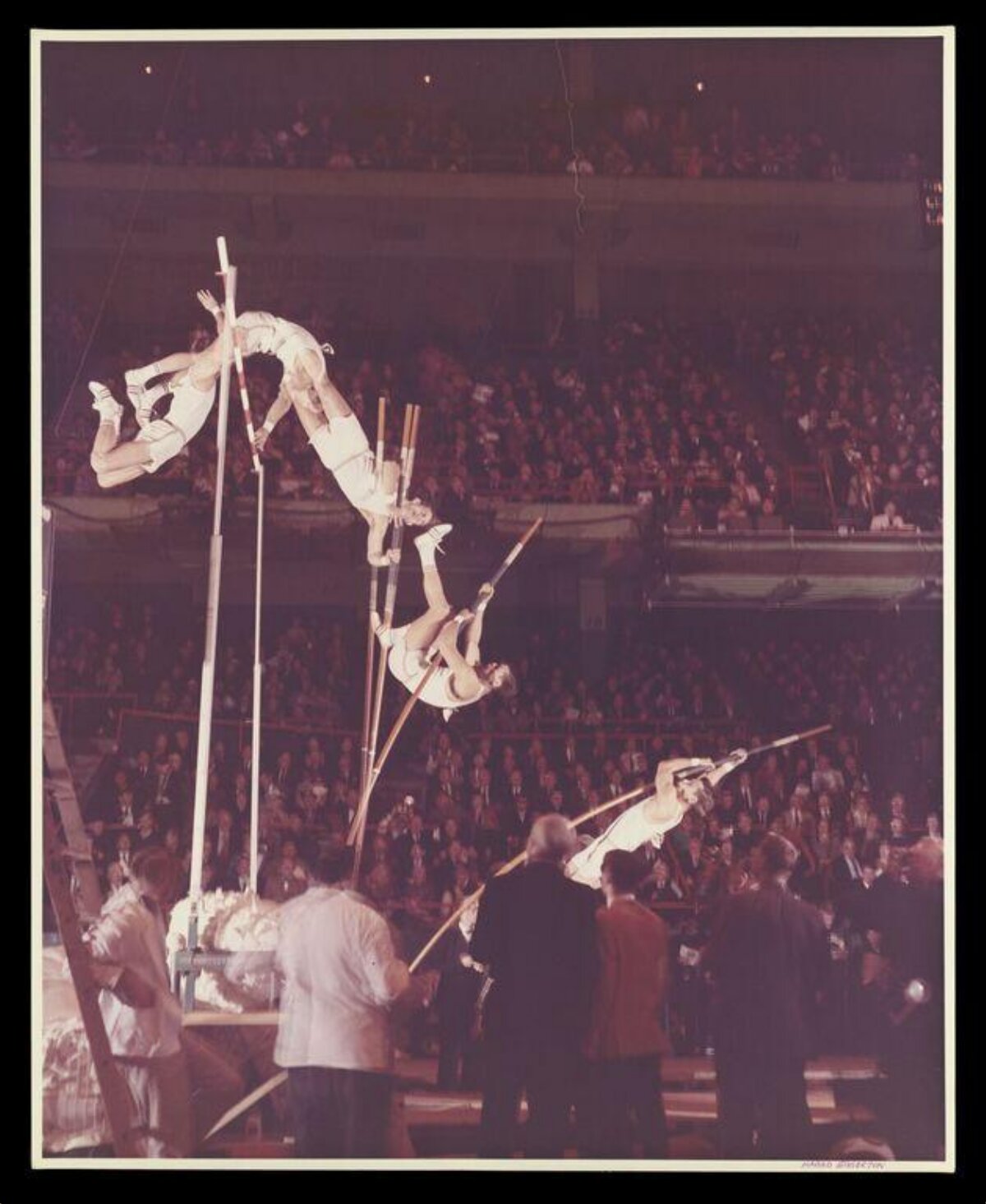 Multiple Pole Vaulters Mid Jump