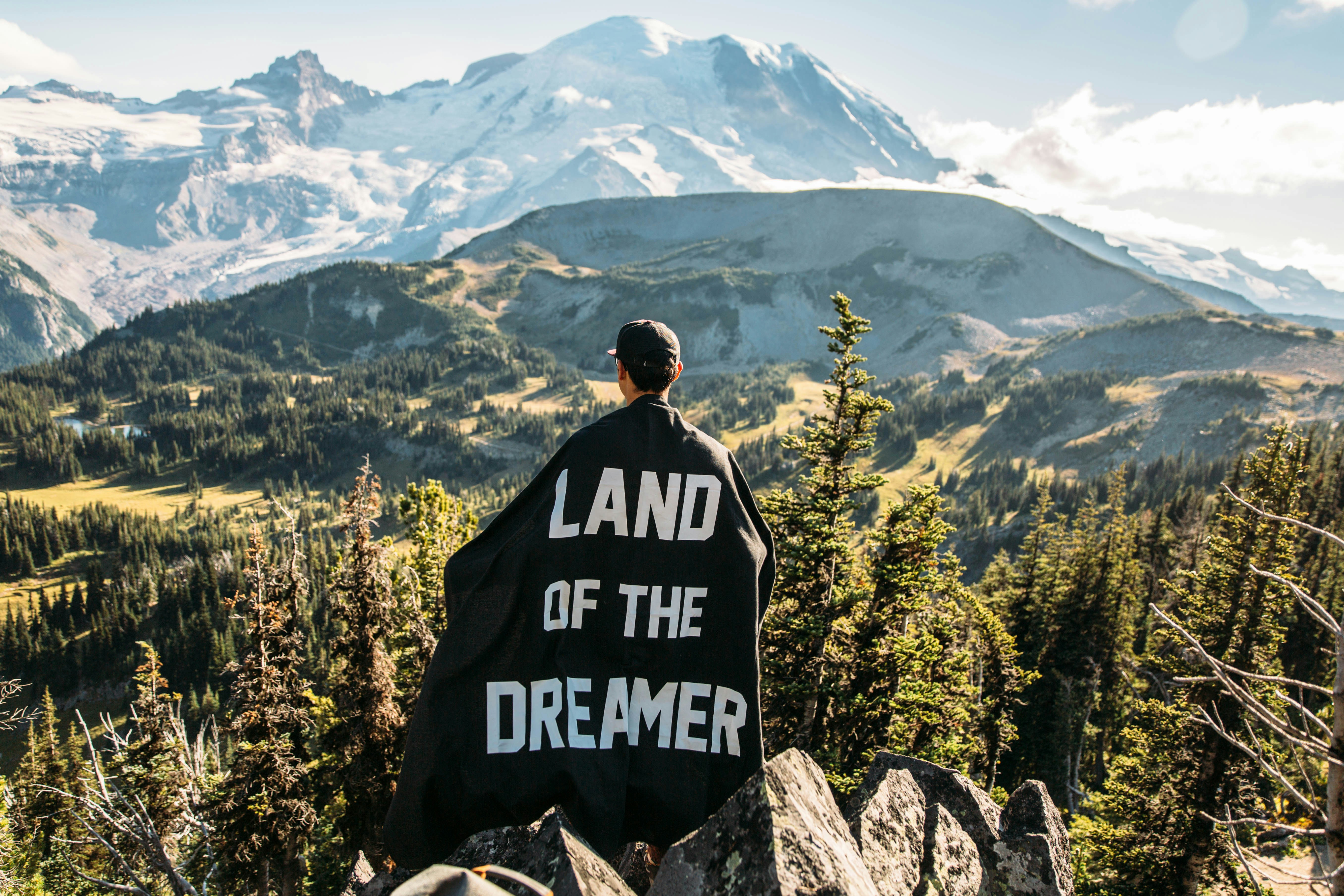 Hiker Overlooks Snow-Capped Mountain