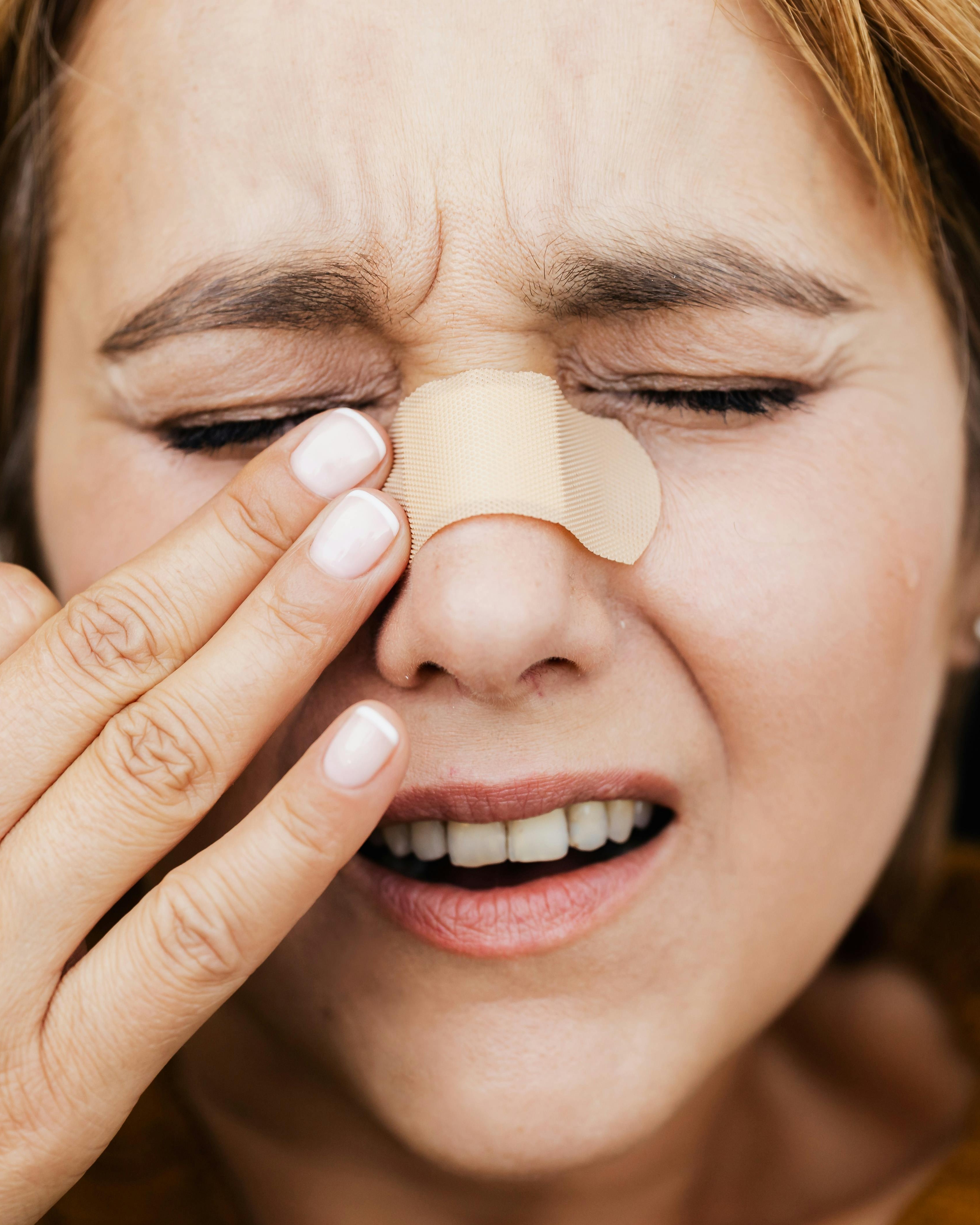 Woman Removing Nose Strip