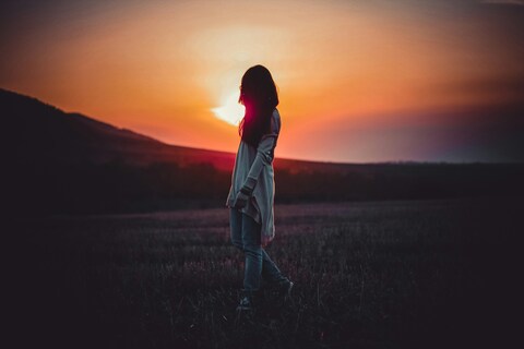 Woman Silhouette in Field at Sunset