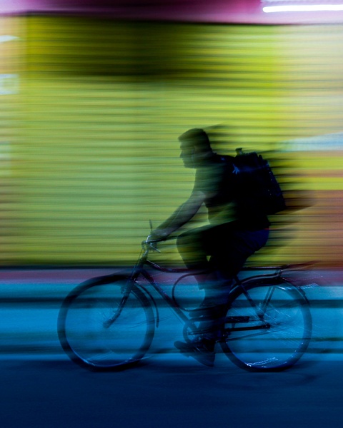 Speeding Cyclist Silhouette at Night