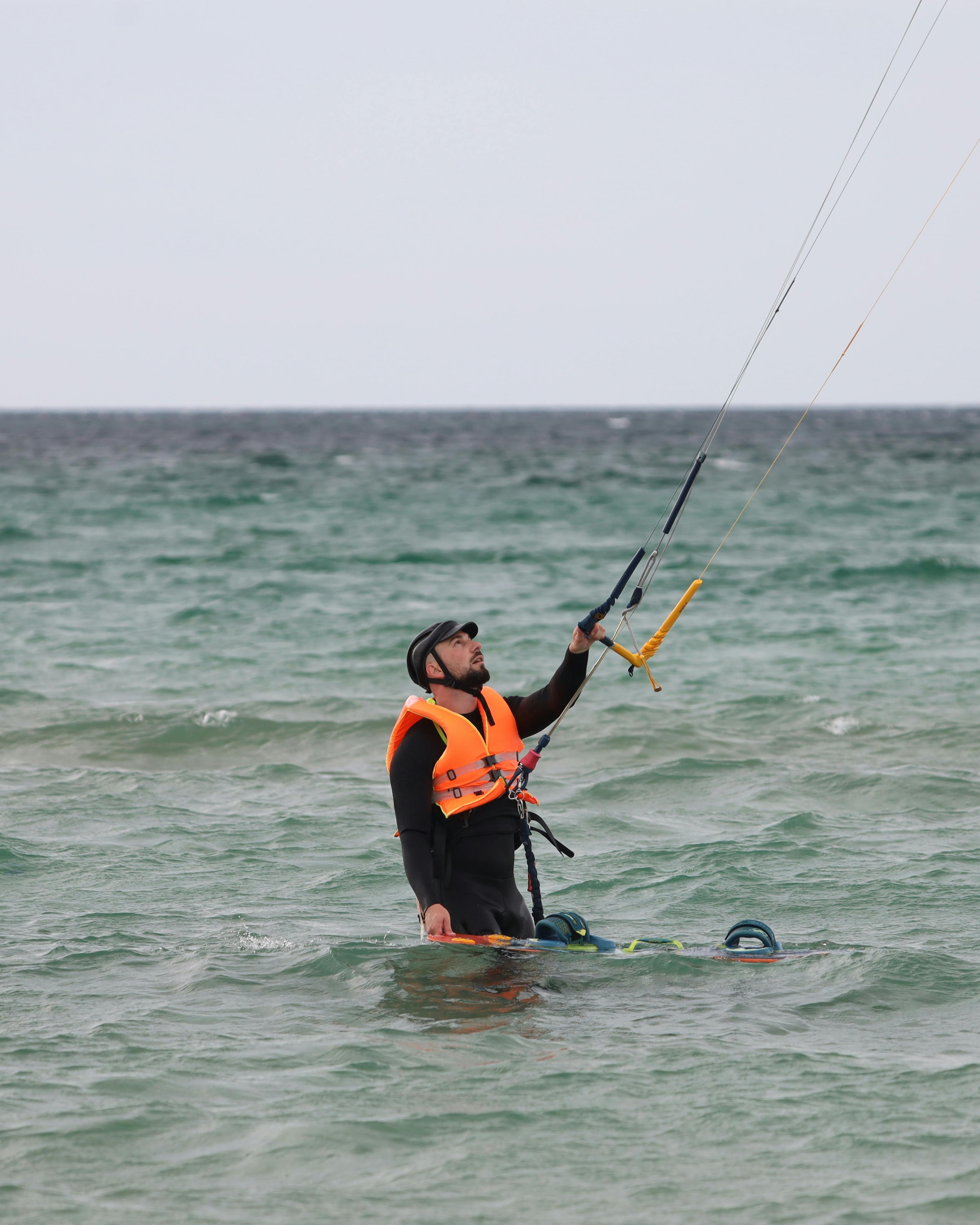 Kitesurfer Preparing in Ocean Water