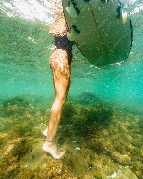 Underwater View of Surfer on Seabed