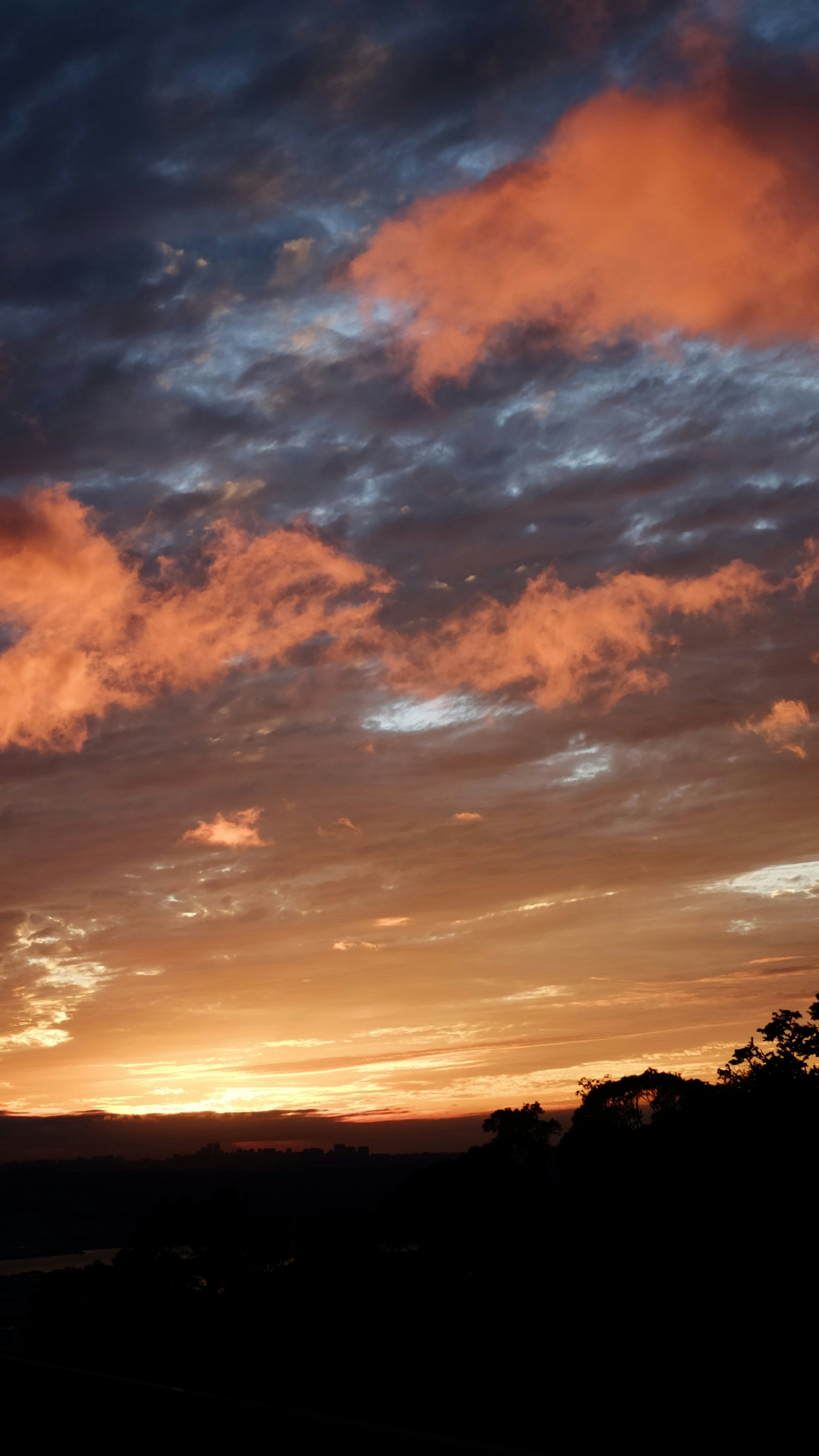 Sunset Sky Over Silhouetted Landscape