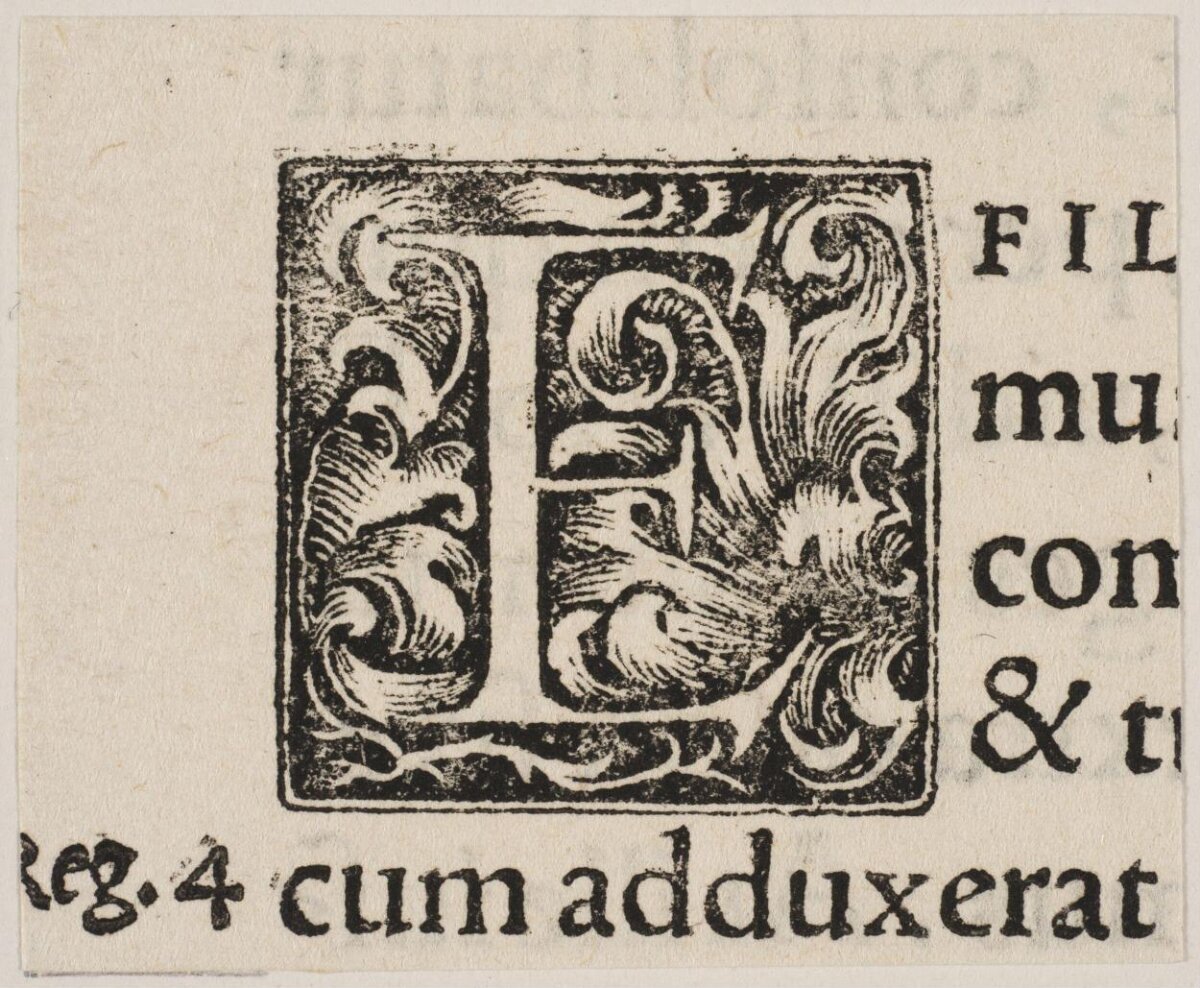 Ornate Woodcut Initial E on Antique Text