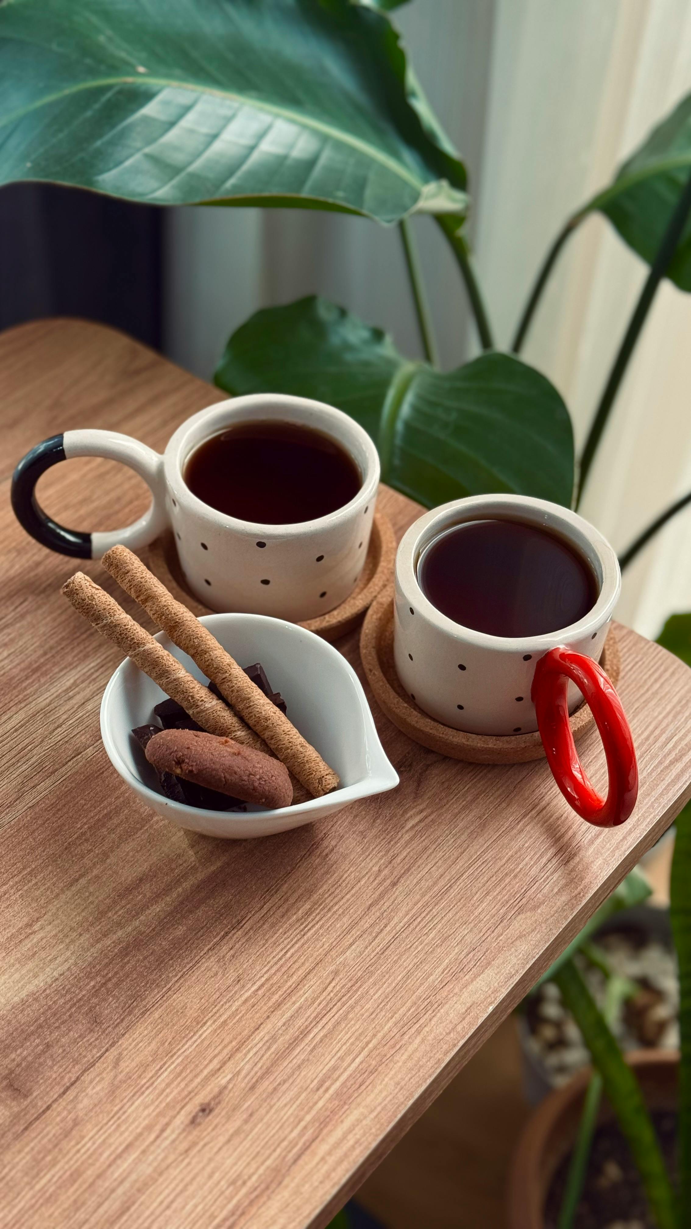 Two Coffee Mugs With Sweet Snacks