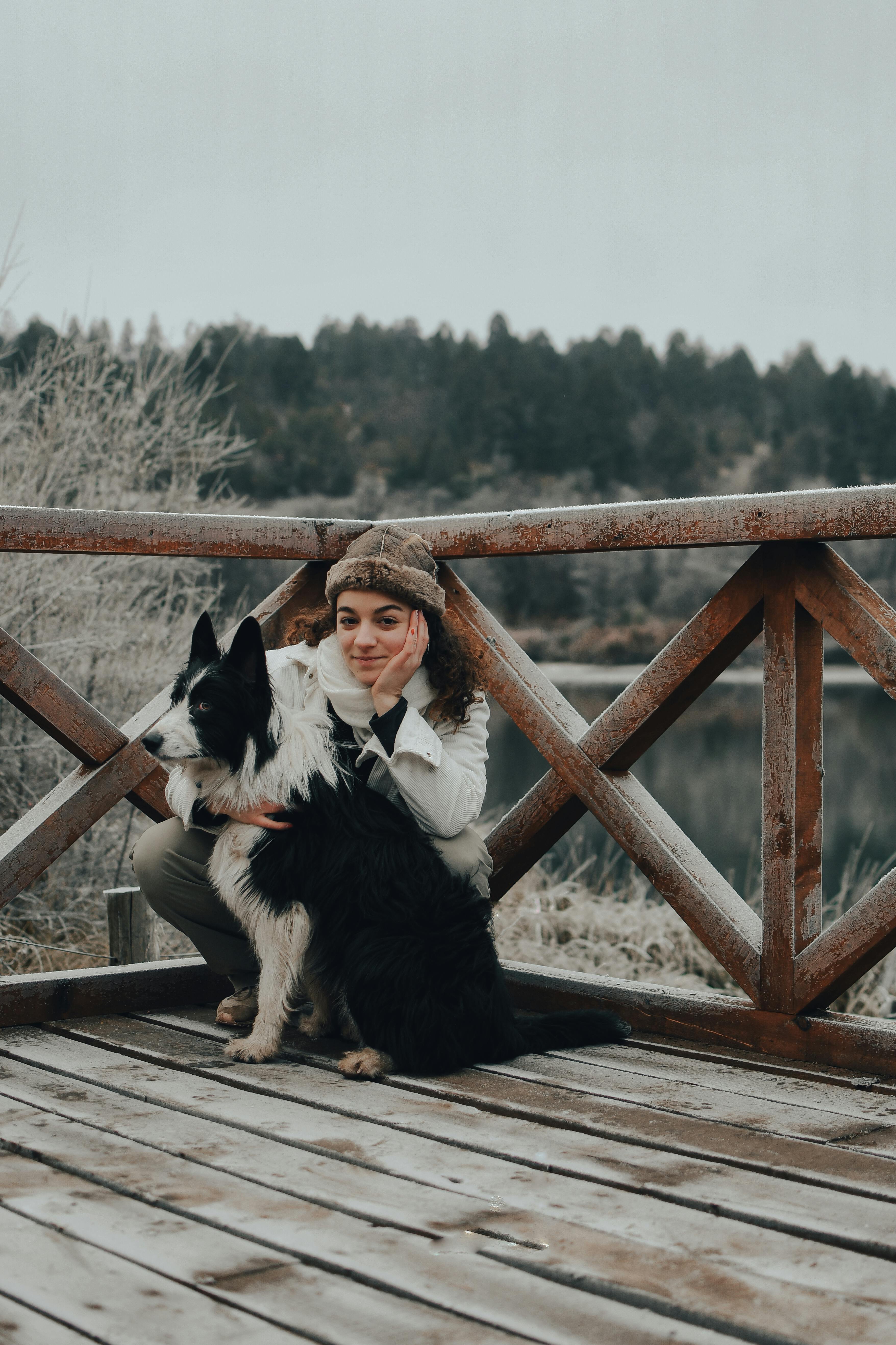 Woman and Dog on Frosty Wooden Bridge