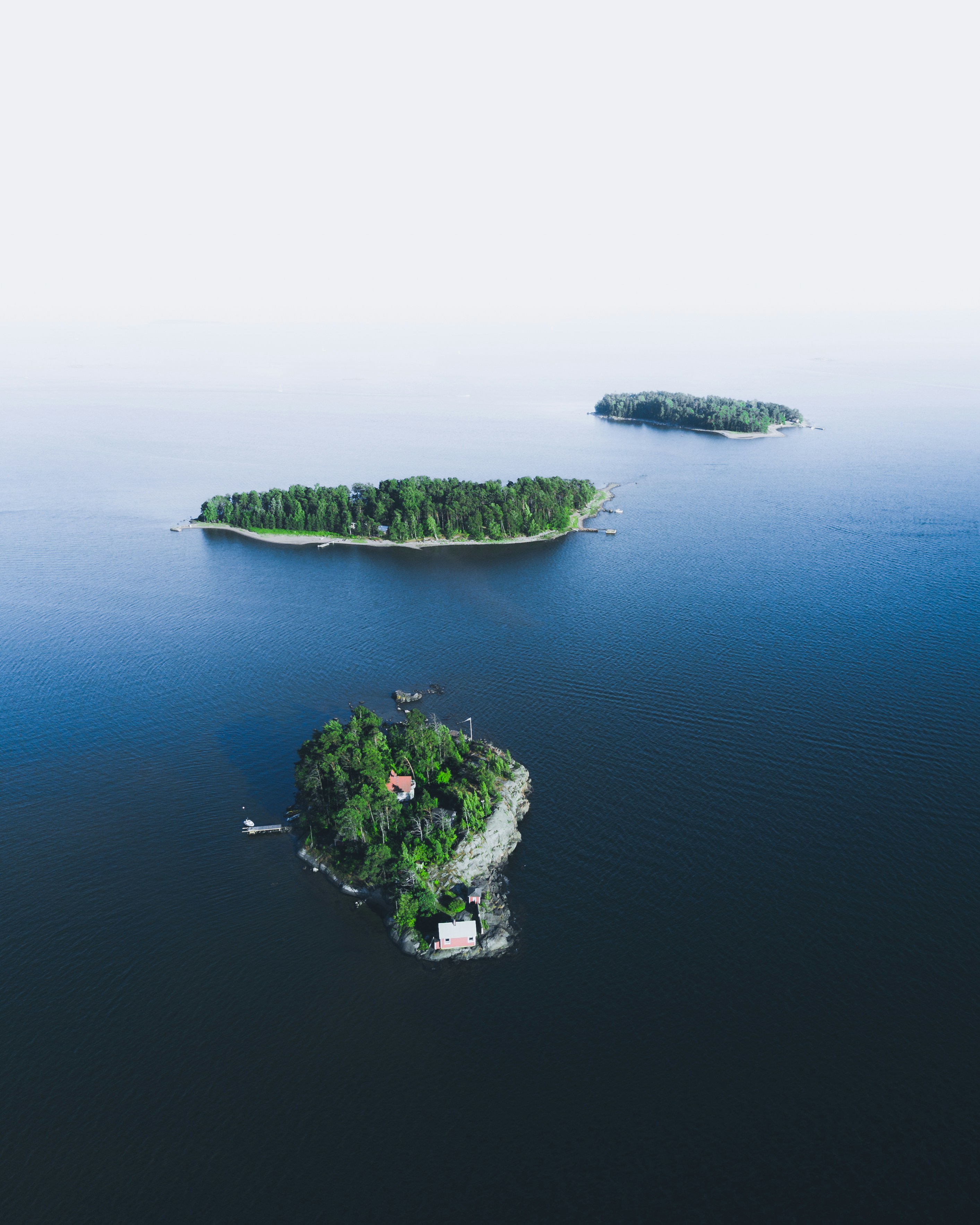 Three Forested Islands on Calm Blue Sea