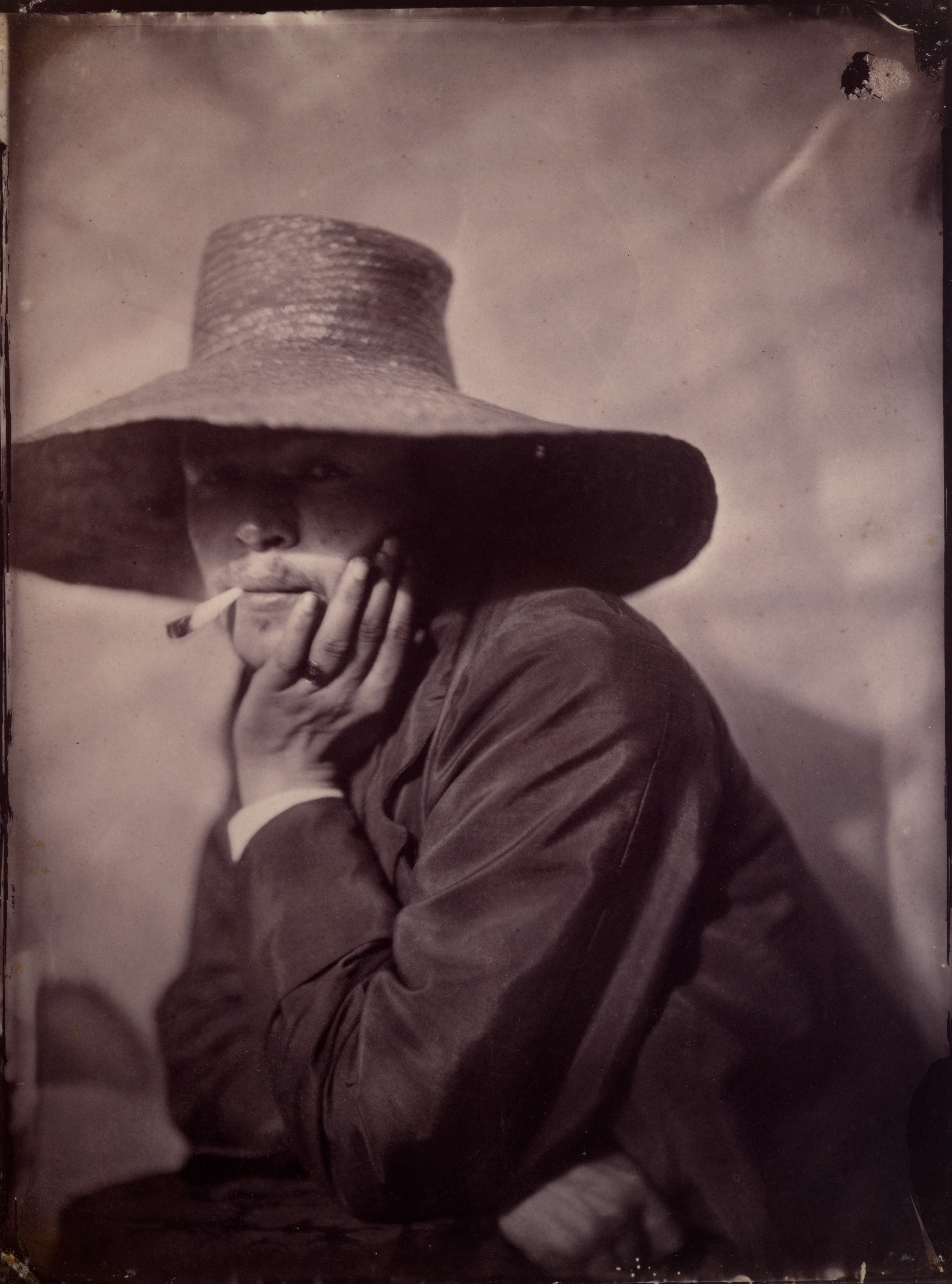Portrait of Smoking Man in Wide Brim Hat