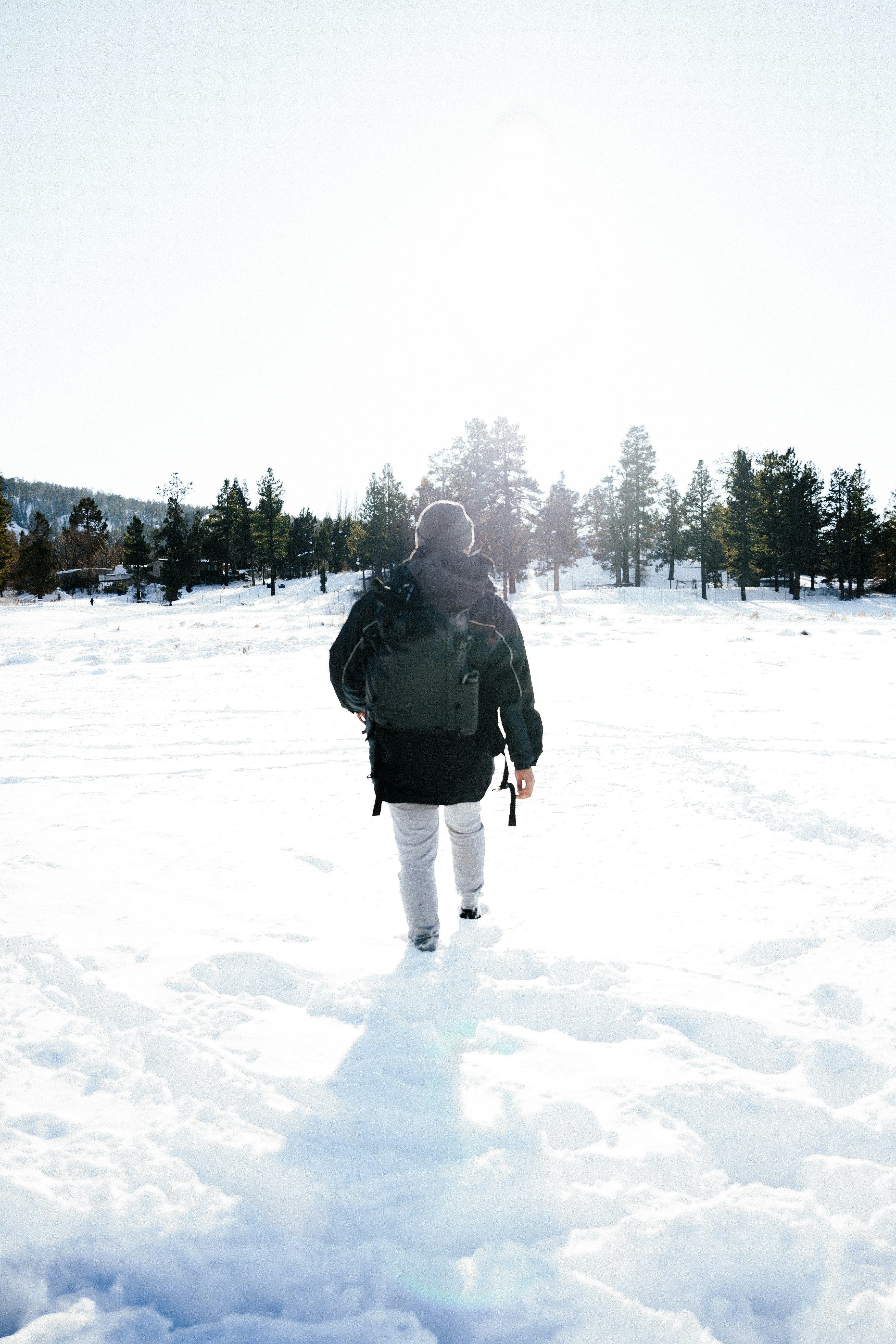 Hiker Walking Through Snowy Field
