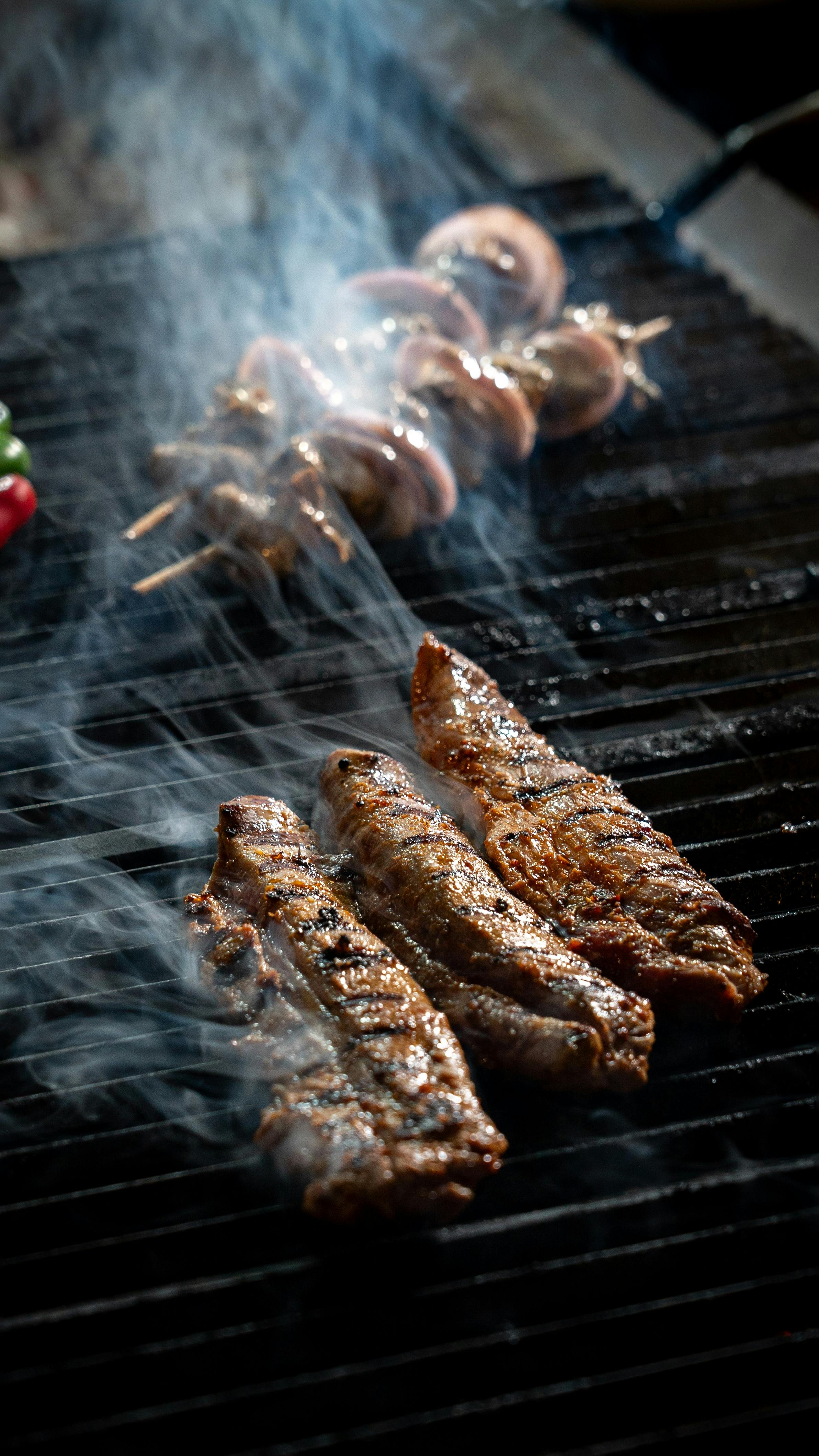 Grilled Meats on Smoking Barbecue Grill