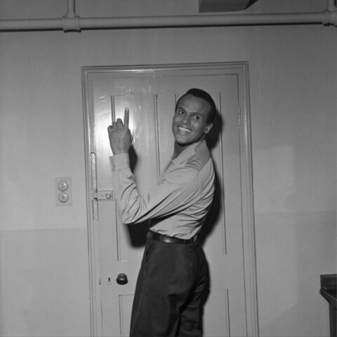 Smiling Harry Belafonte Pointing At Door