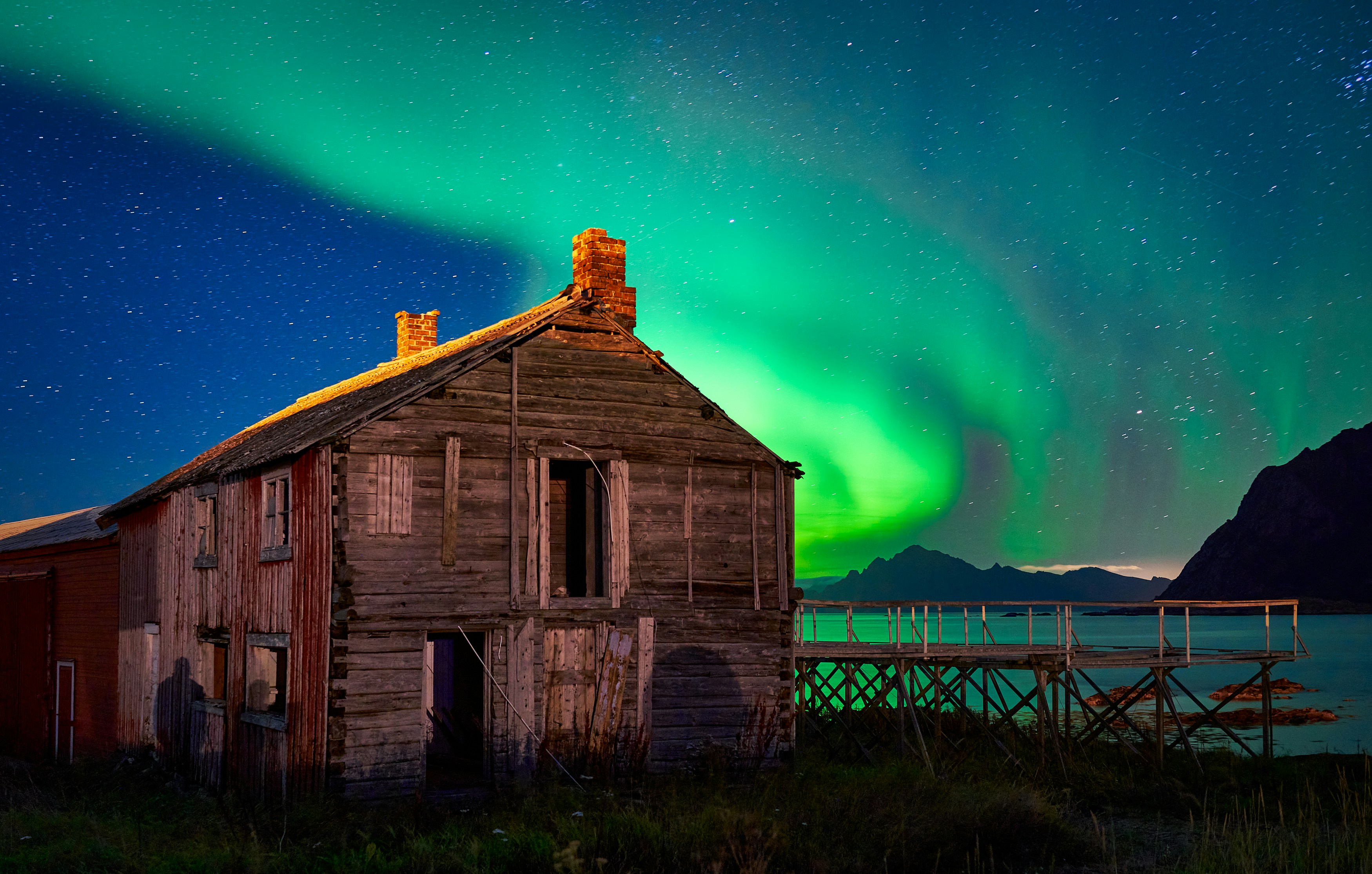 Aurora Over Old Wooden House by Sea