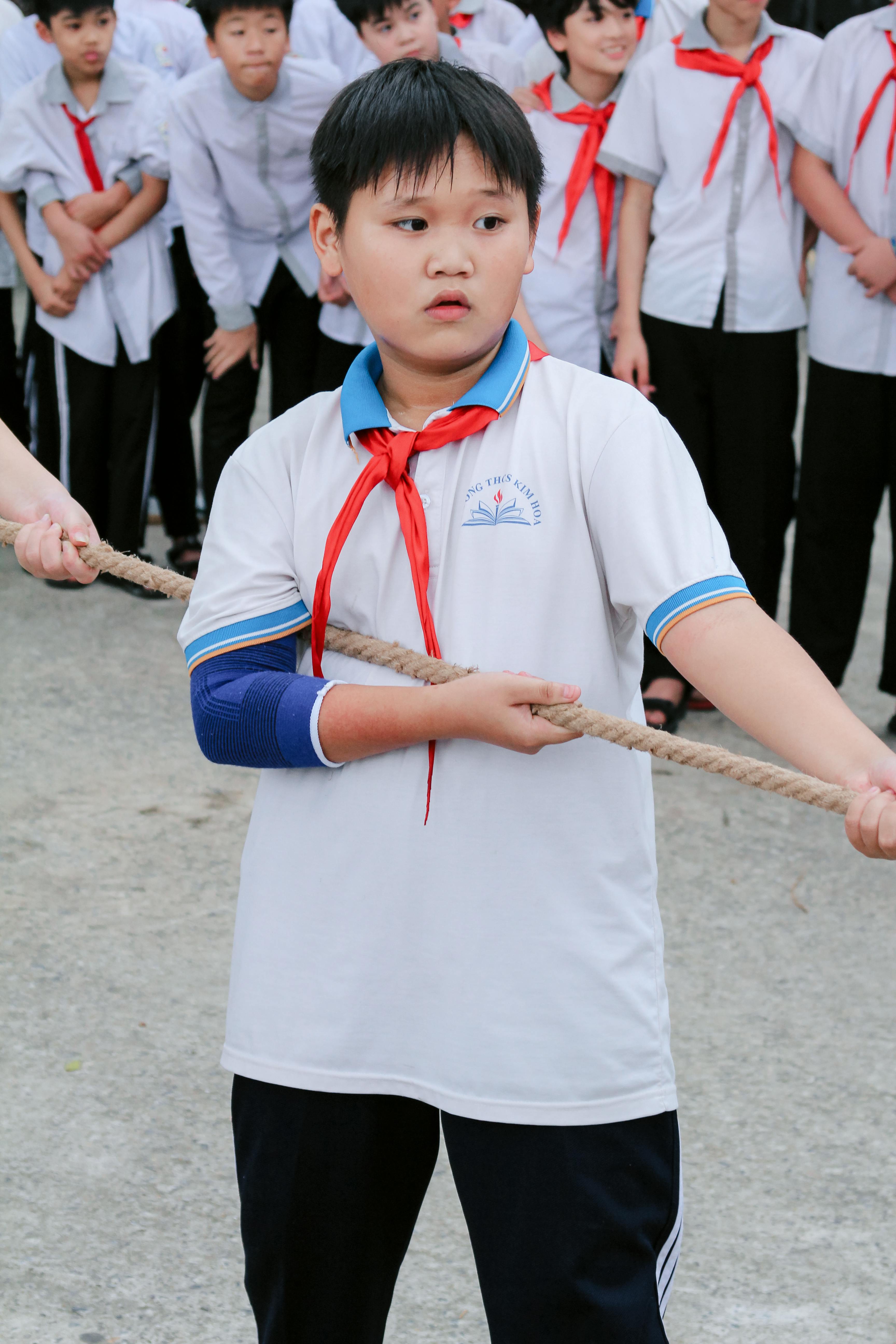 Schoolboy Participating in Tug of War