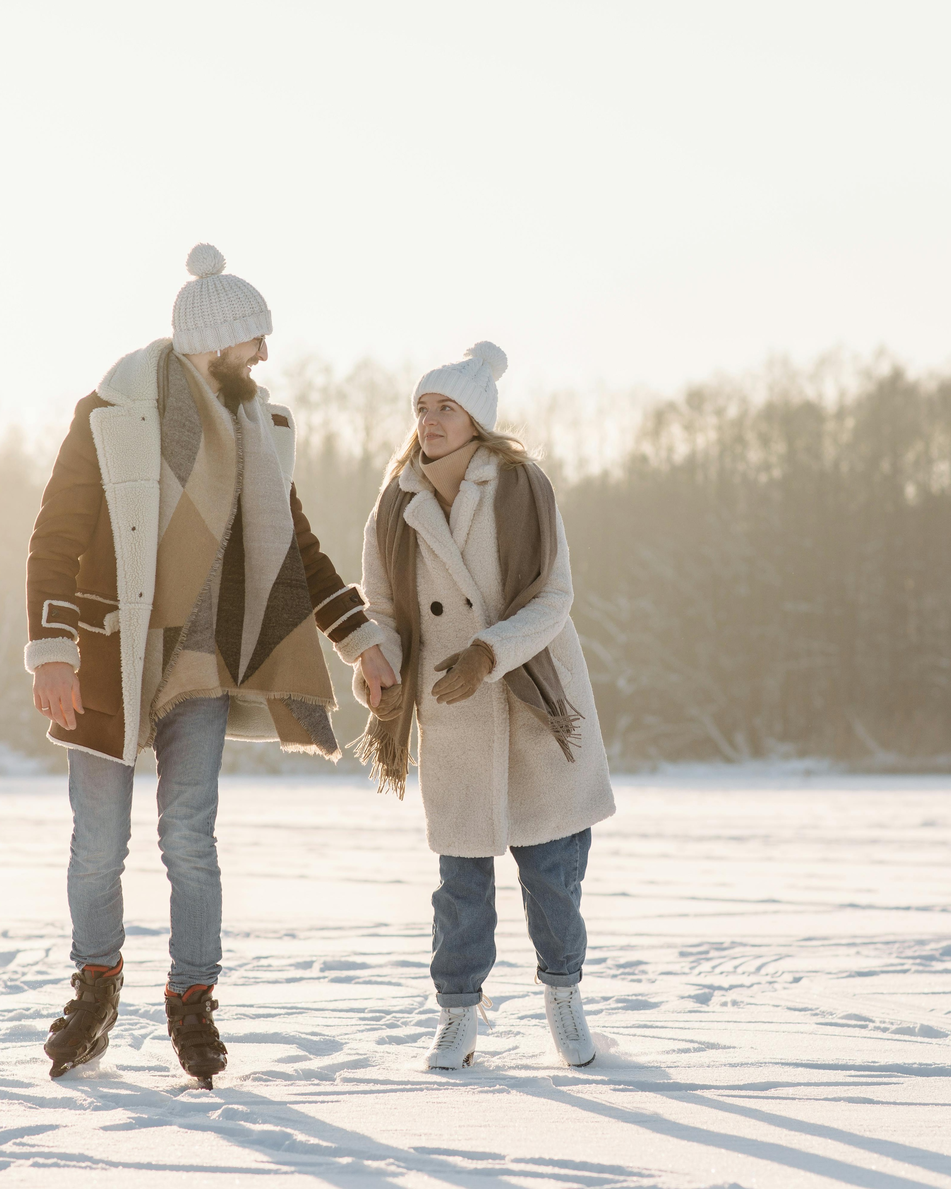 Couple Ice Skating on Frozen Winter Lake
