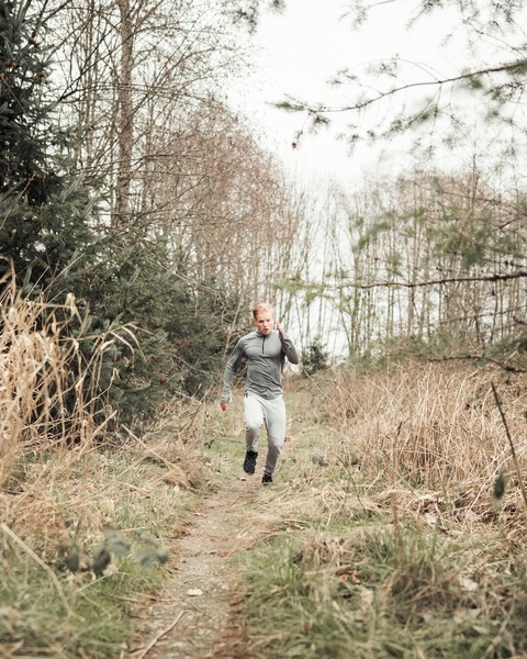 Man Trail Running on Forest Path