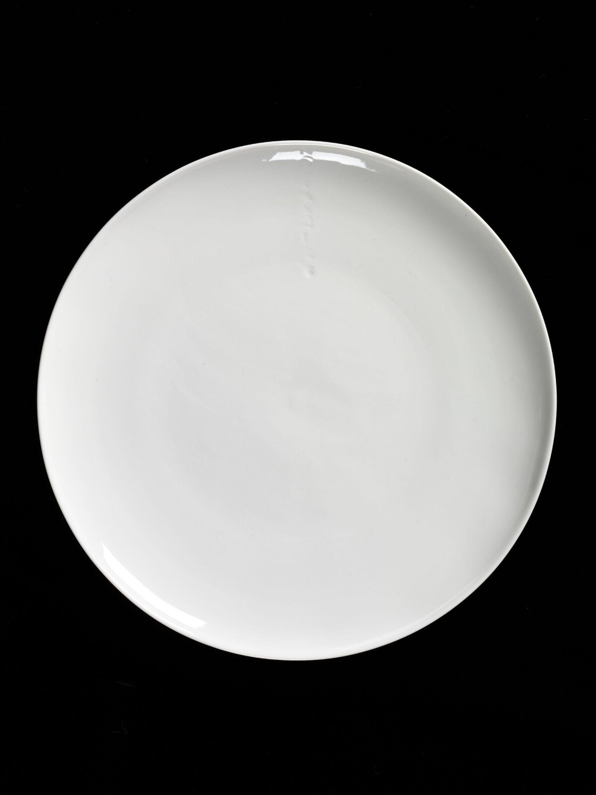 White Round Plate on Black Background