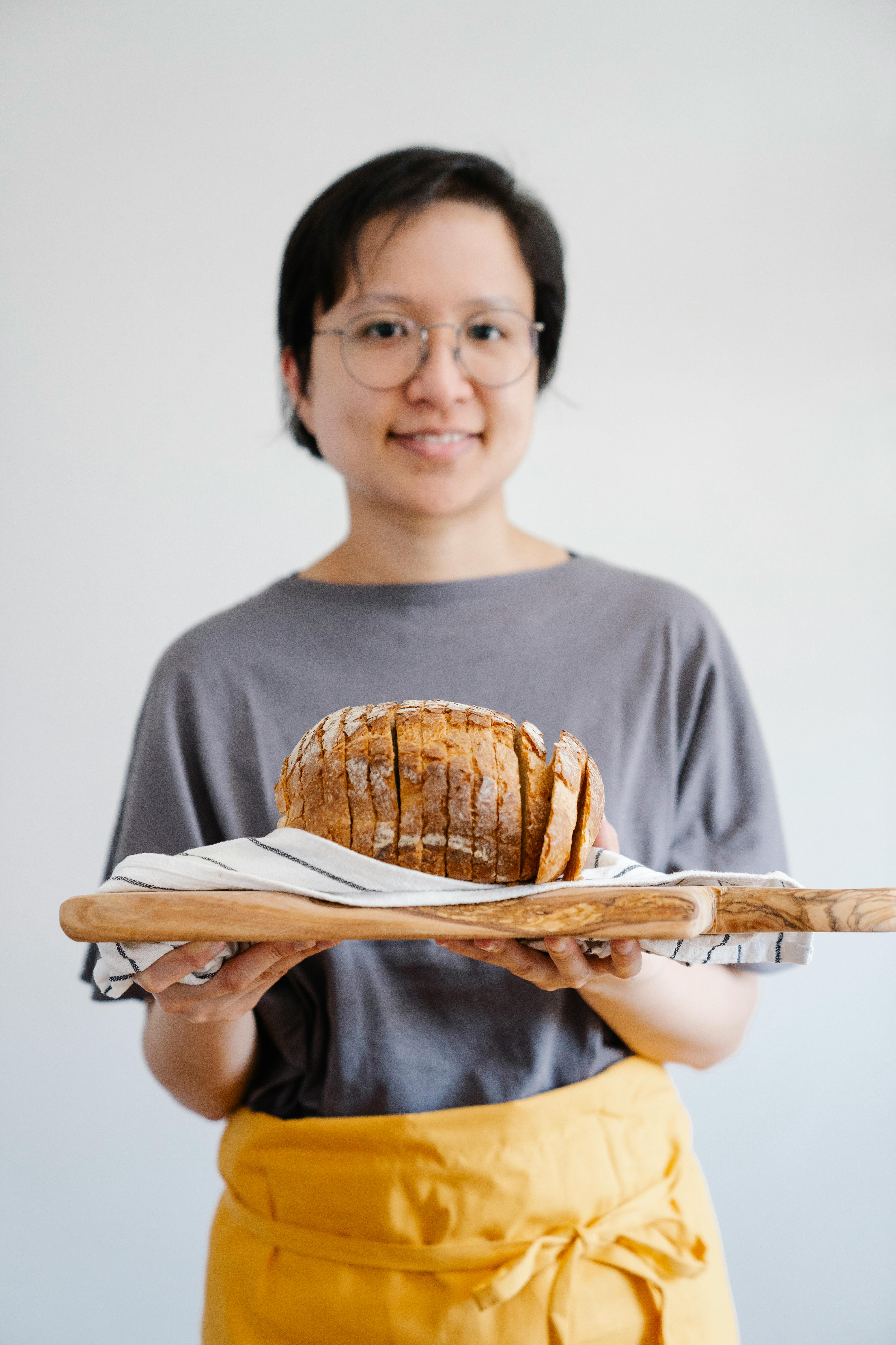Woman Holding Sliced Homemade Bread