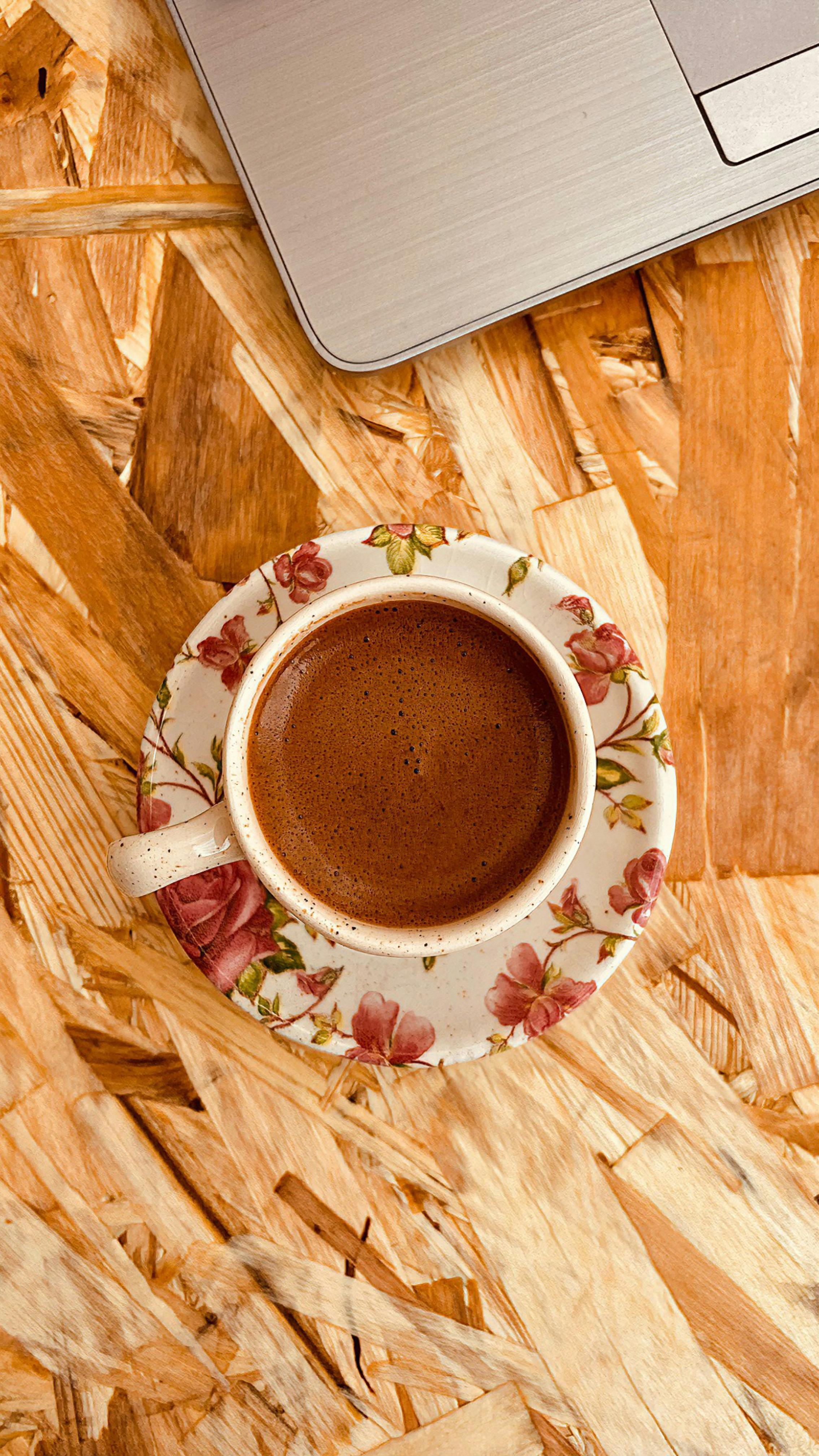 Coffee and Laptop on Wooden Desk