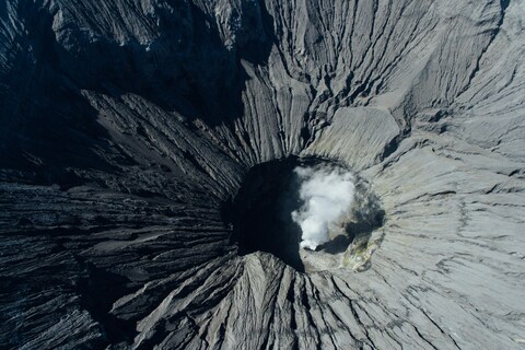 Aerial View of Steaming Volcano Crater