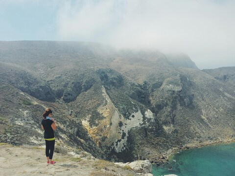 Hiker Overlooking Coastal Cliffs