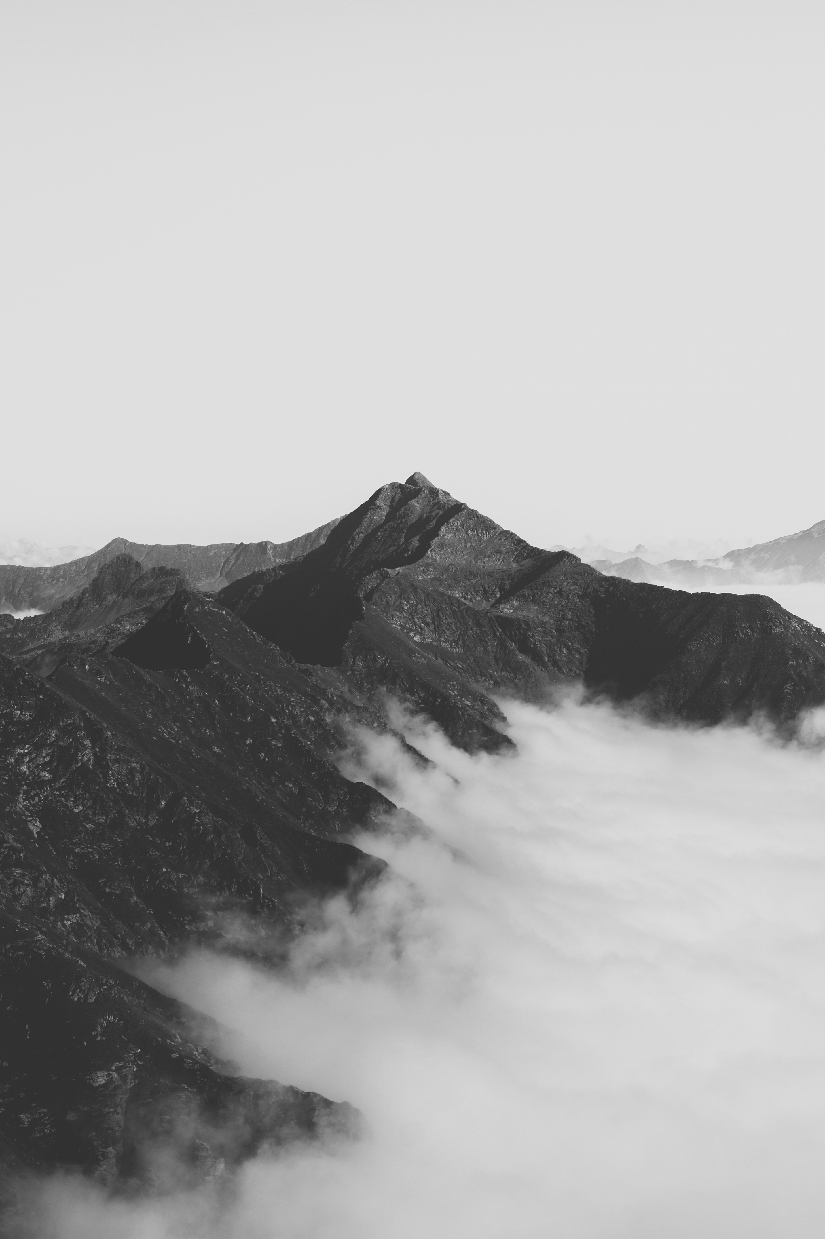 Black and White Mountains Above Clouds