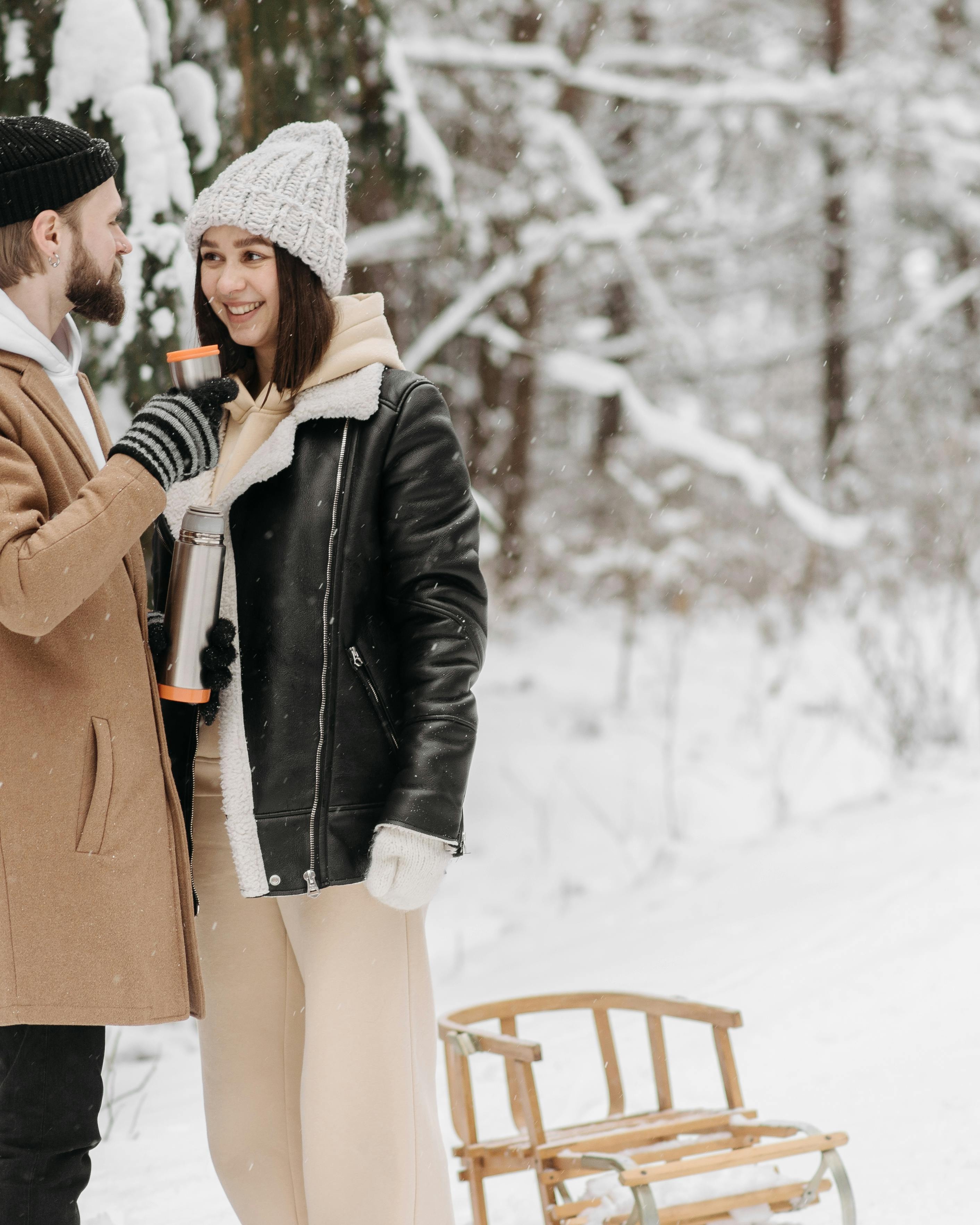 Couple With Thermos in Snowy Forest
