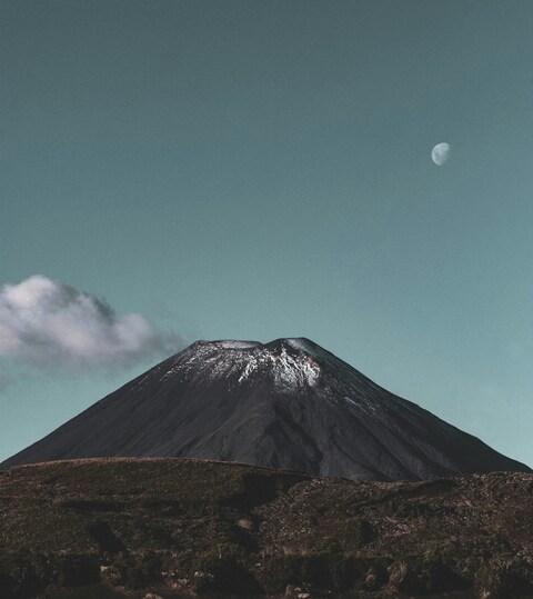 Snow-capped Volcano with Moon in Sky