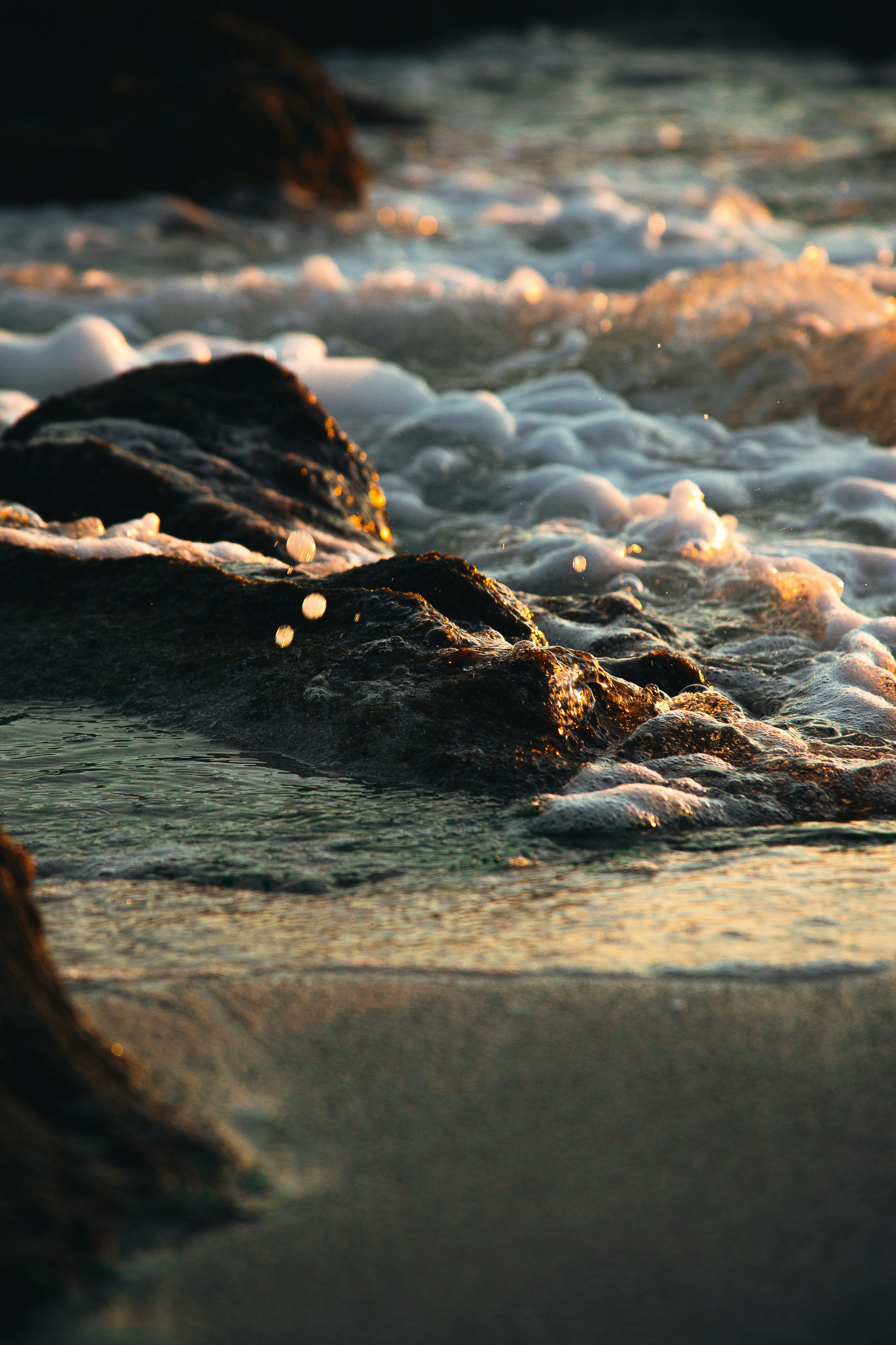 Sunlit Waves Washing Coastal Rocks