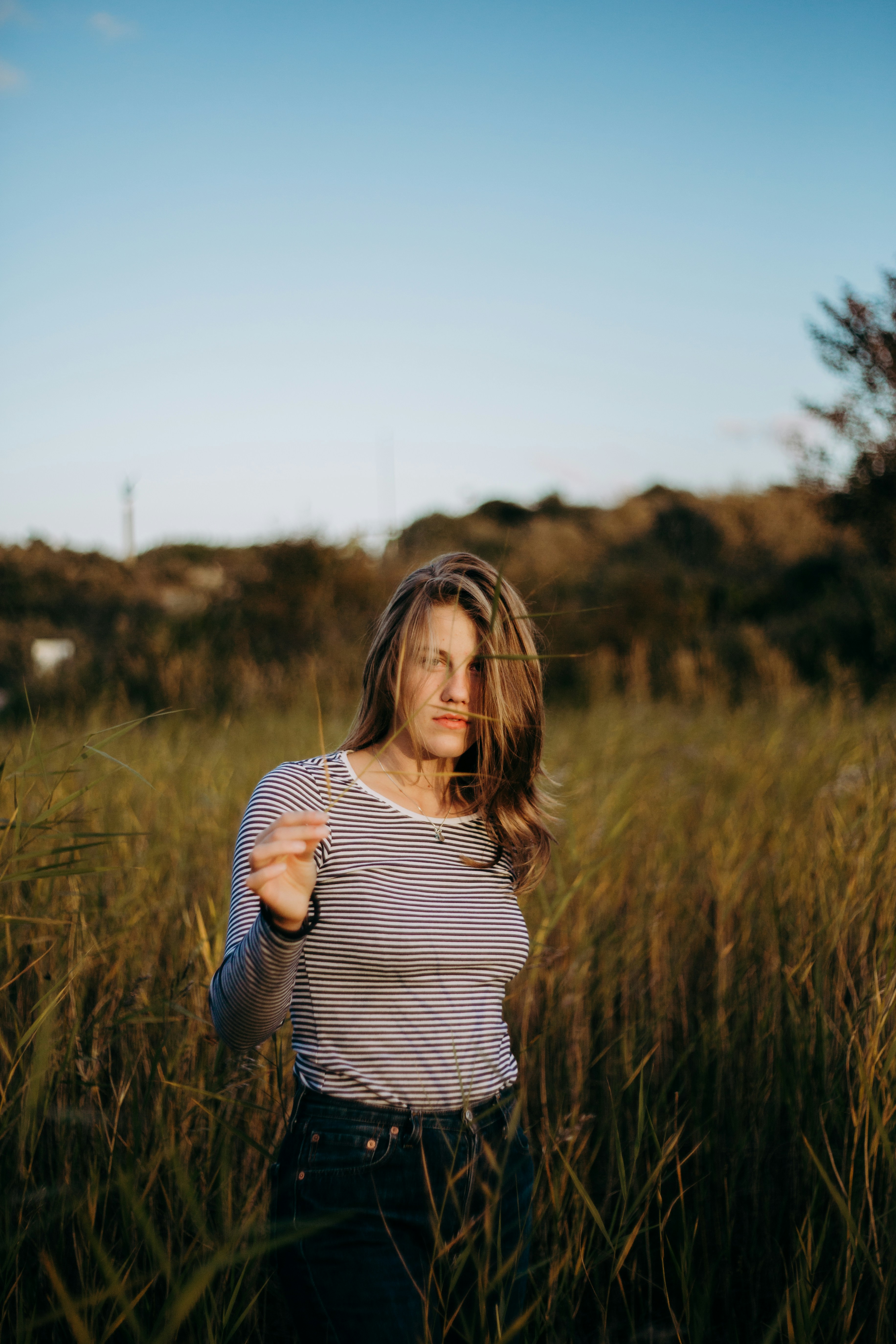 Woman Standing In Tall Grass