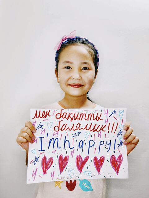 Girl Holding "I'm Happy" Handmade Sign