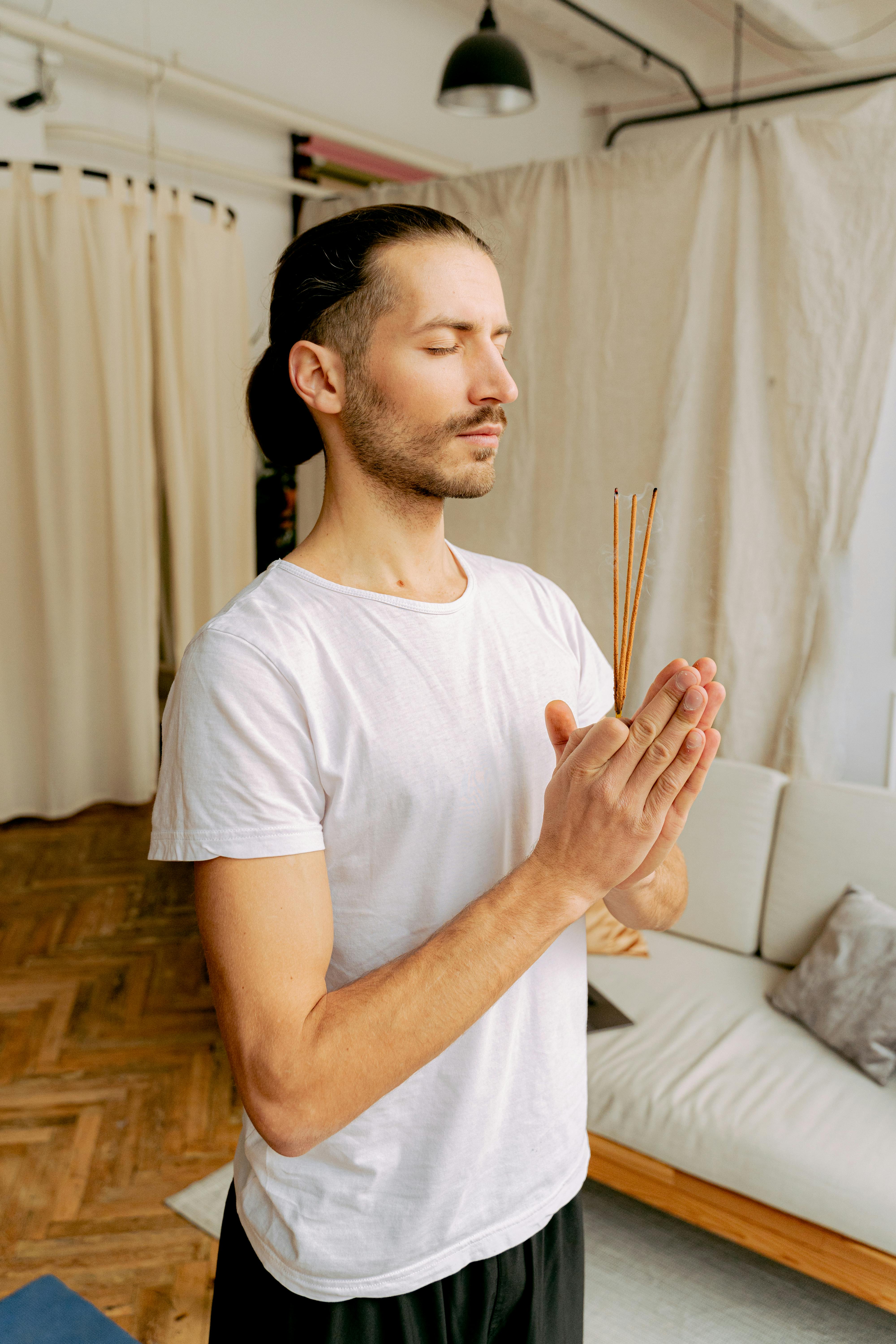 Man Meditating With Burning Incense