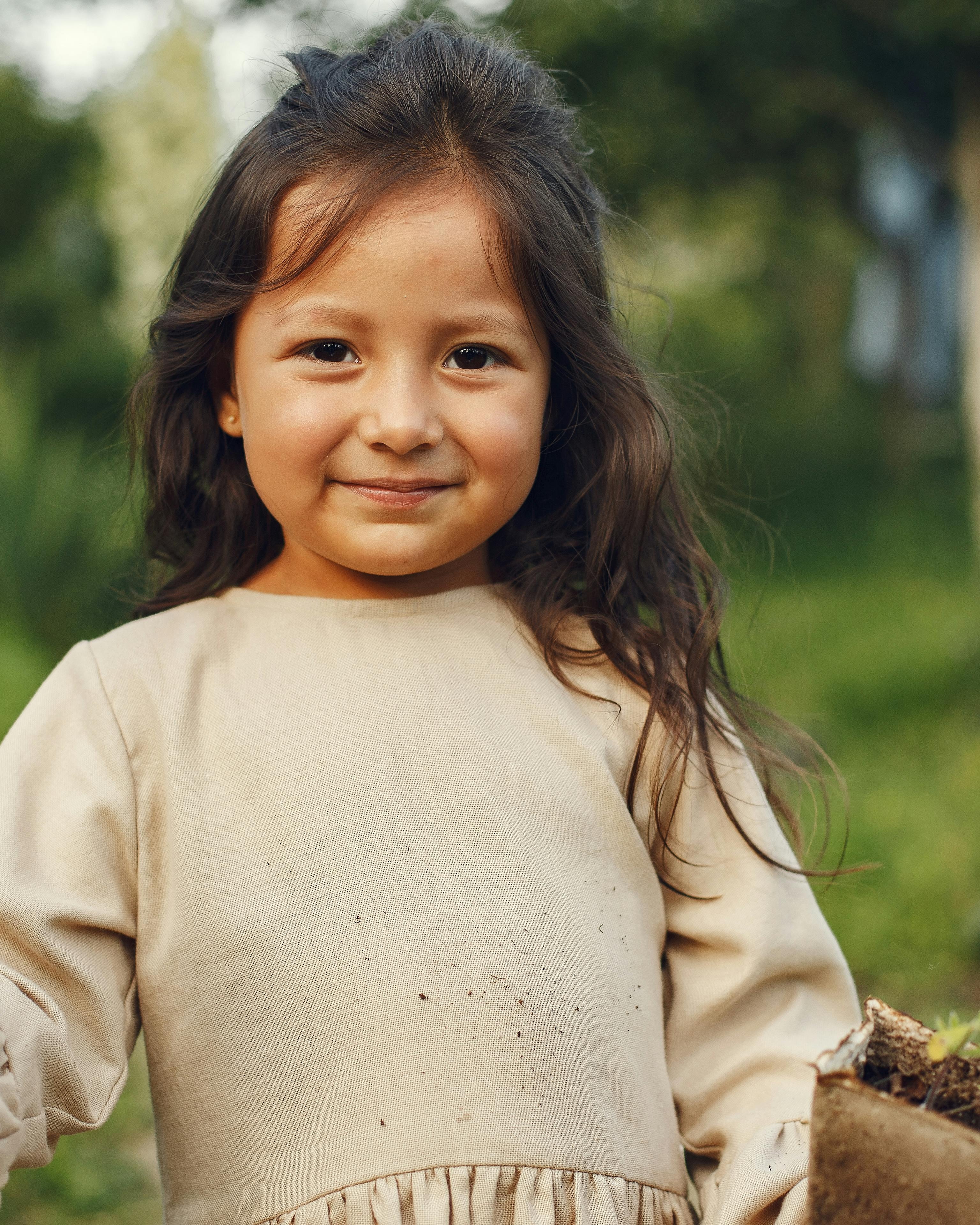 Smiling Young Girl Gardening Outdoors