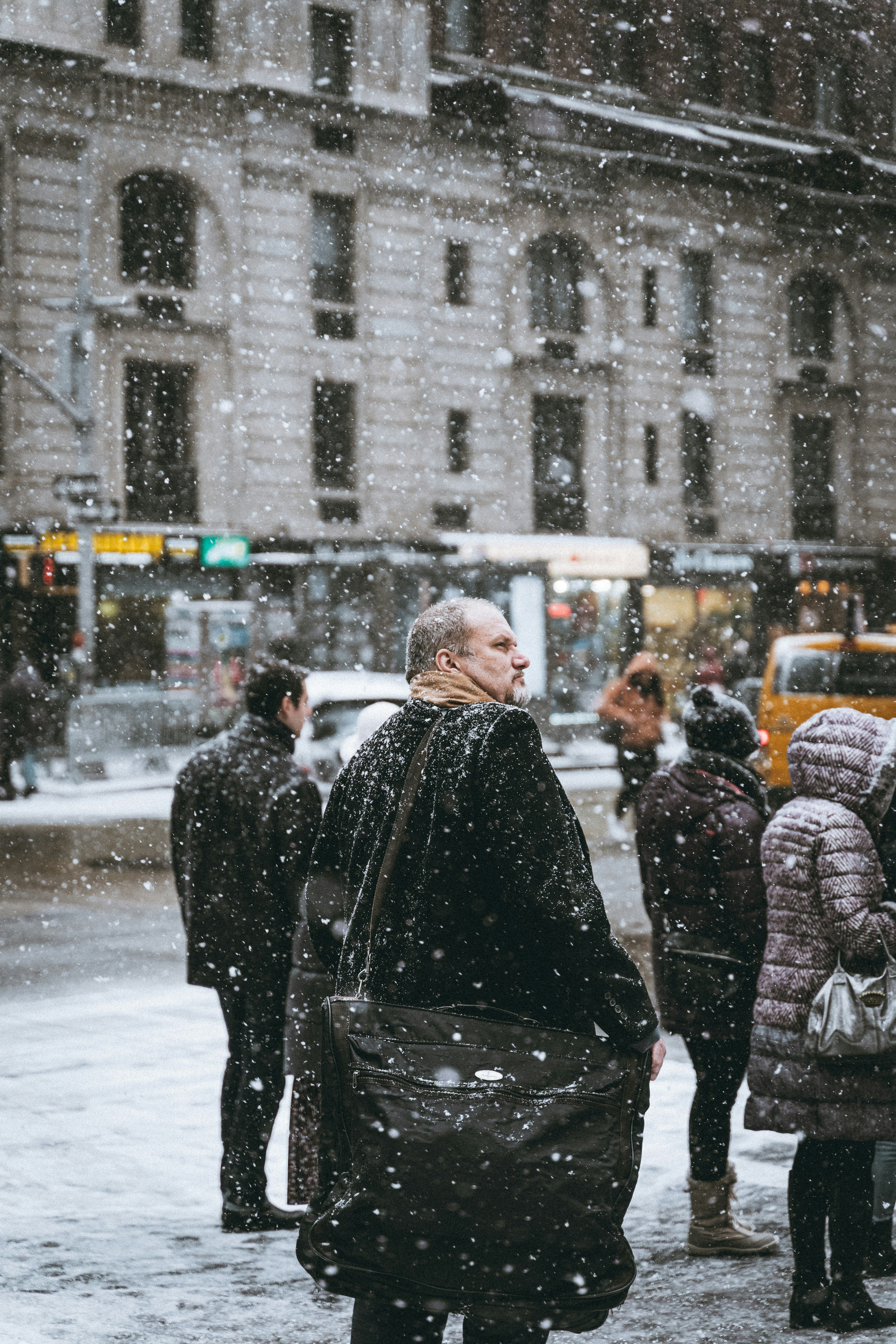 Pedestrians on Snowy City Street