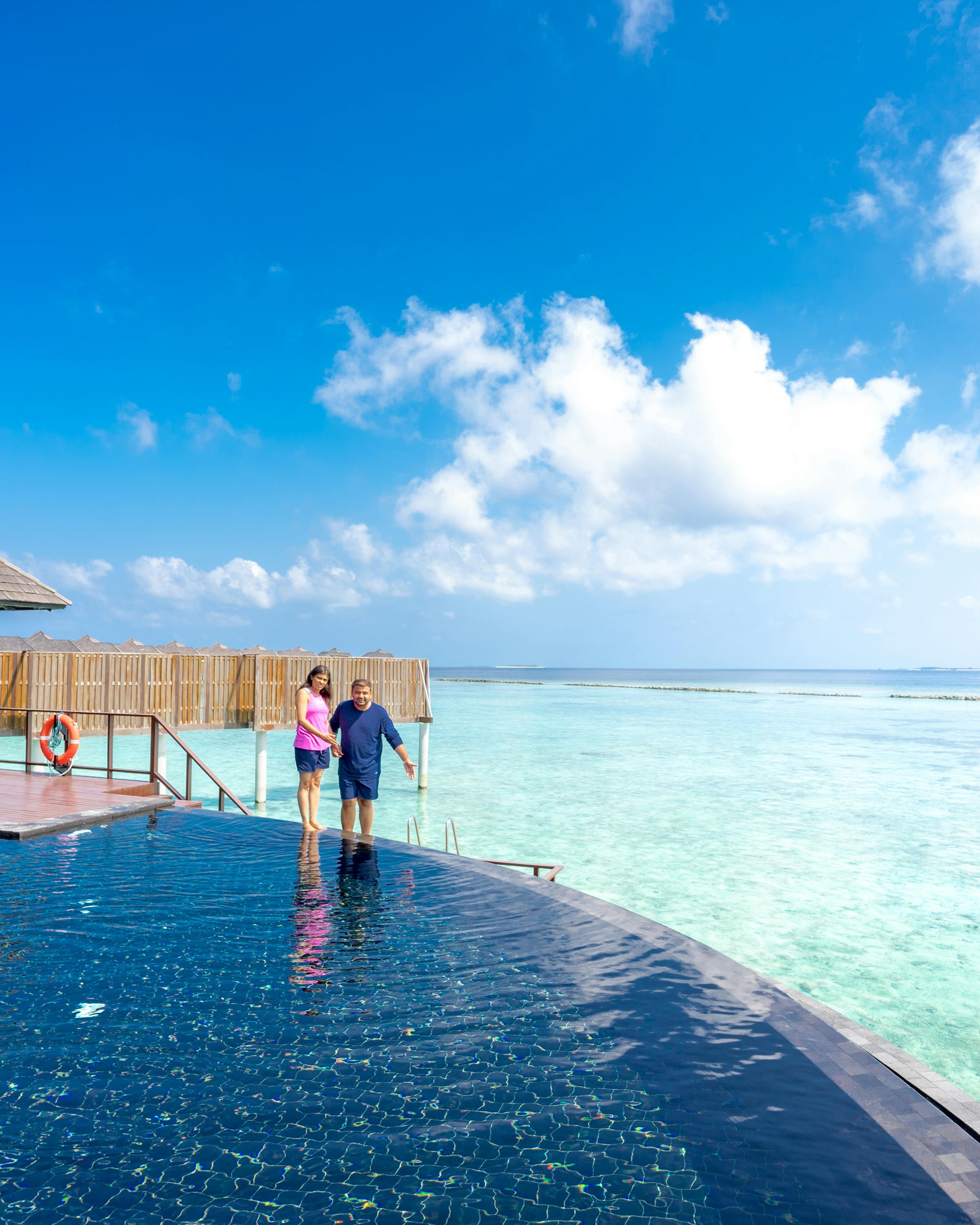 Couple at Tropical Resort Infinity Pool