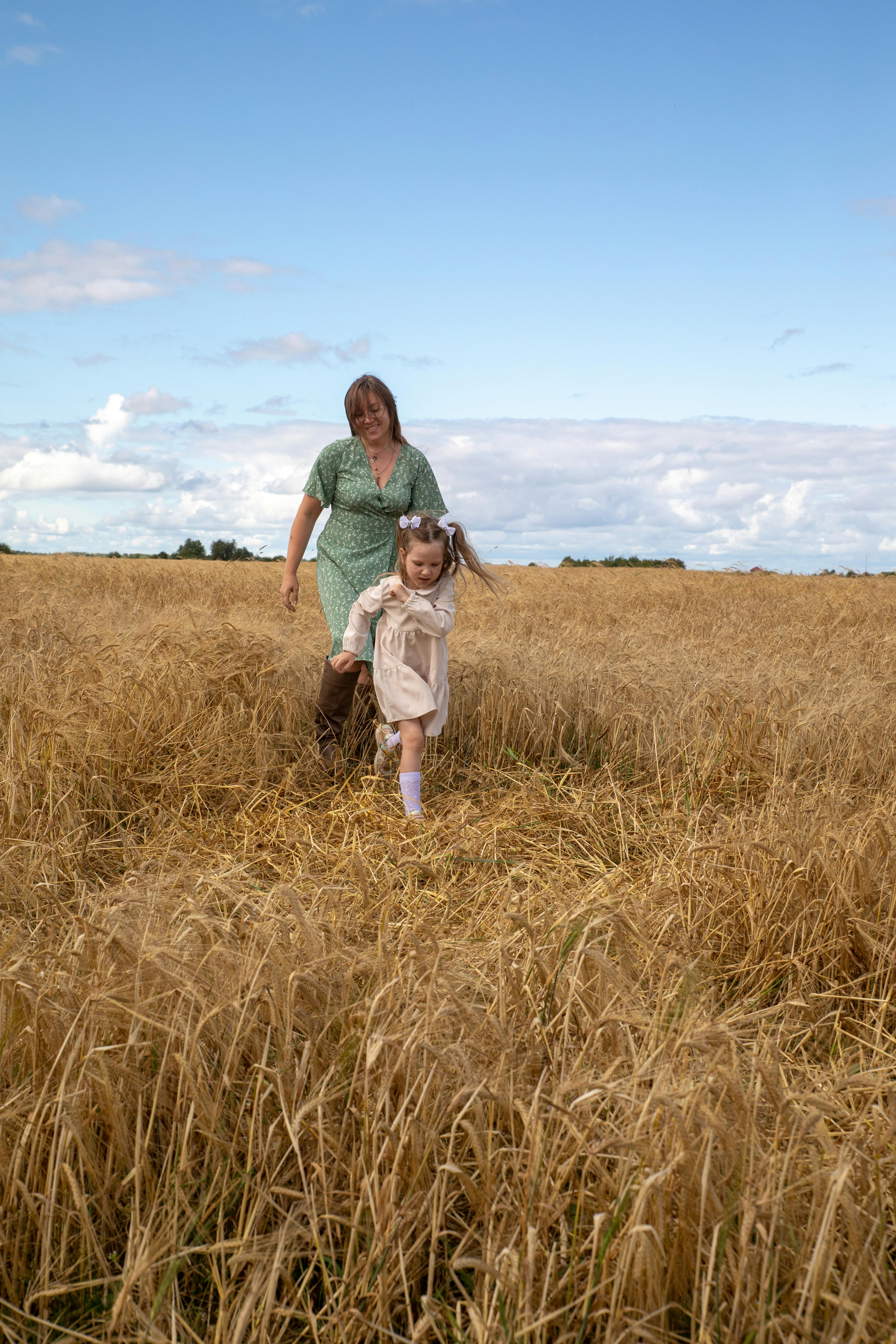 Woman and Girl Walking in Wheat Field