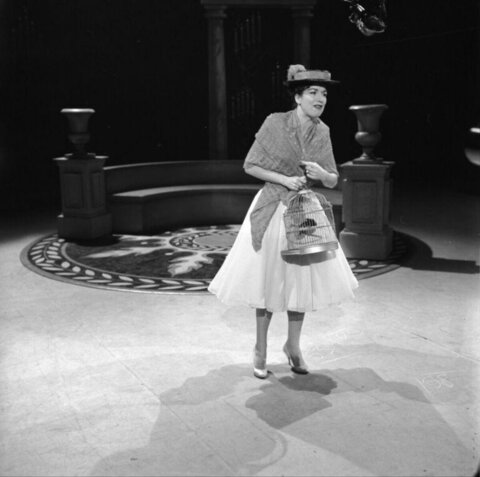 Female Performer Holding Birdcage