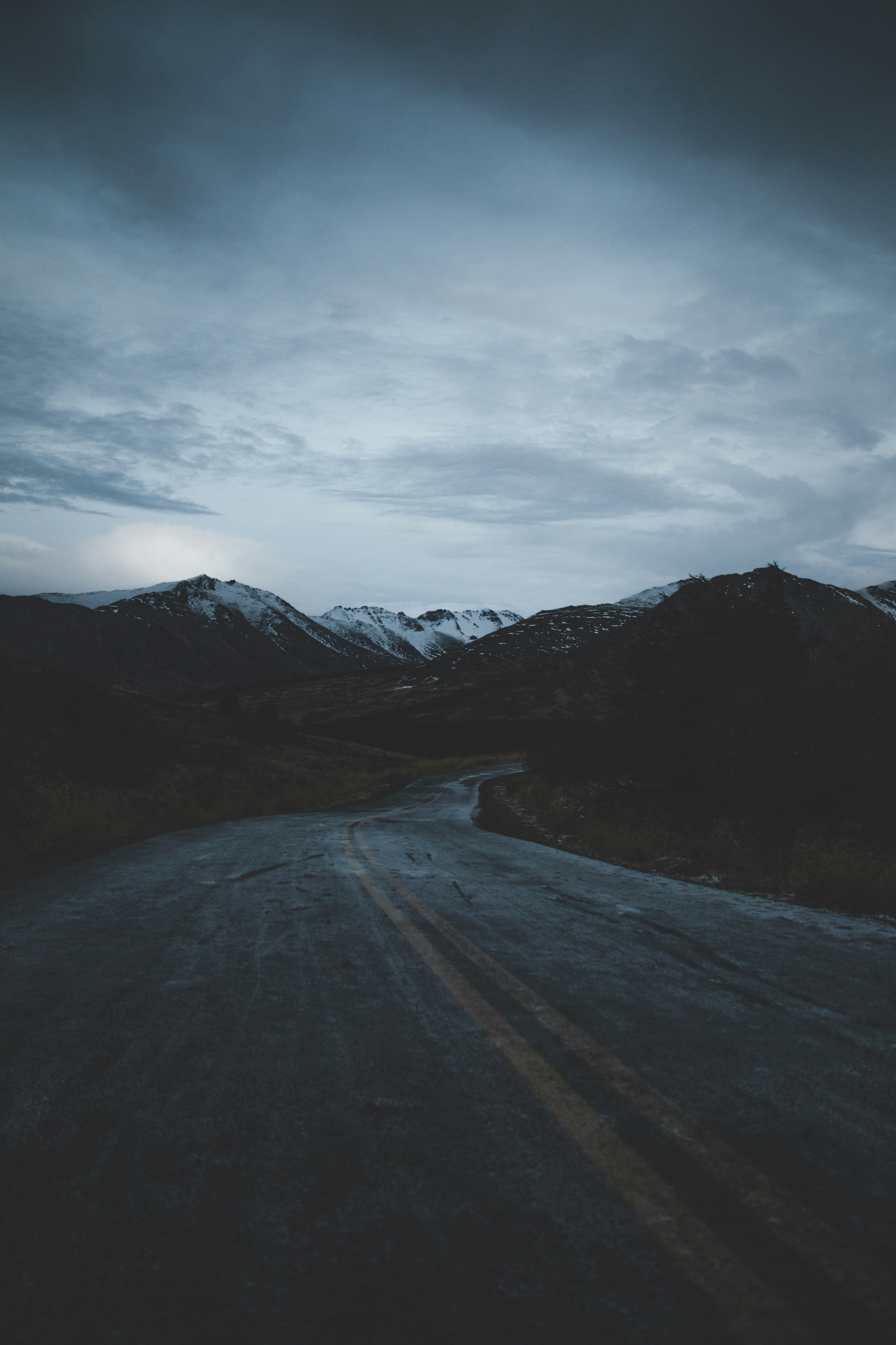 Winding Mountain Road to Snowy Peaks
