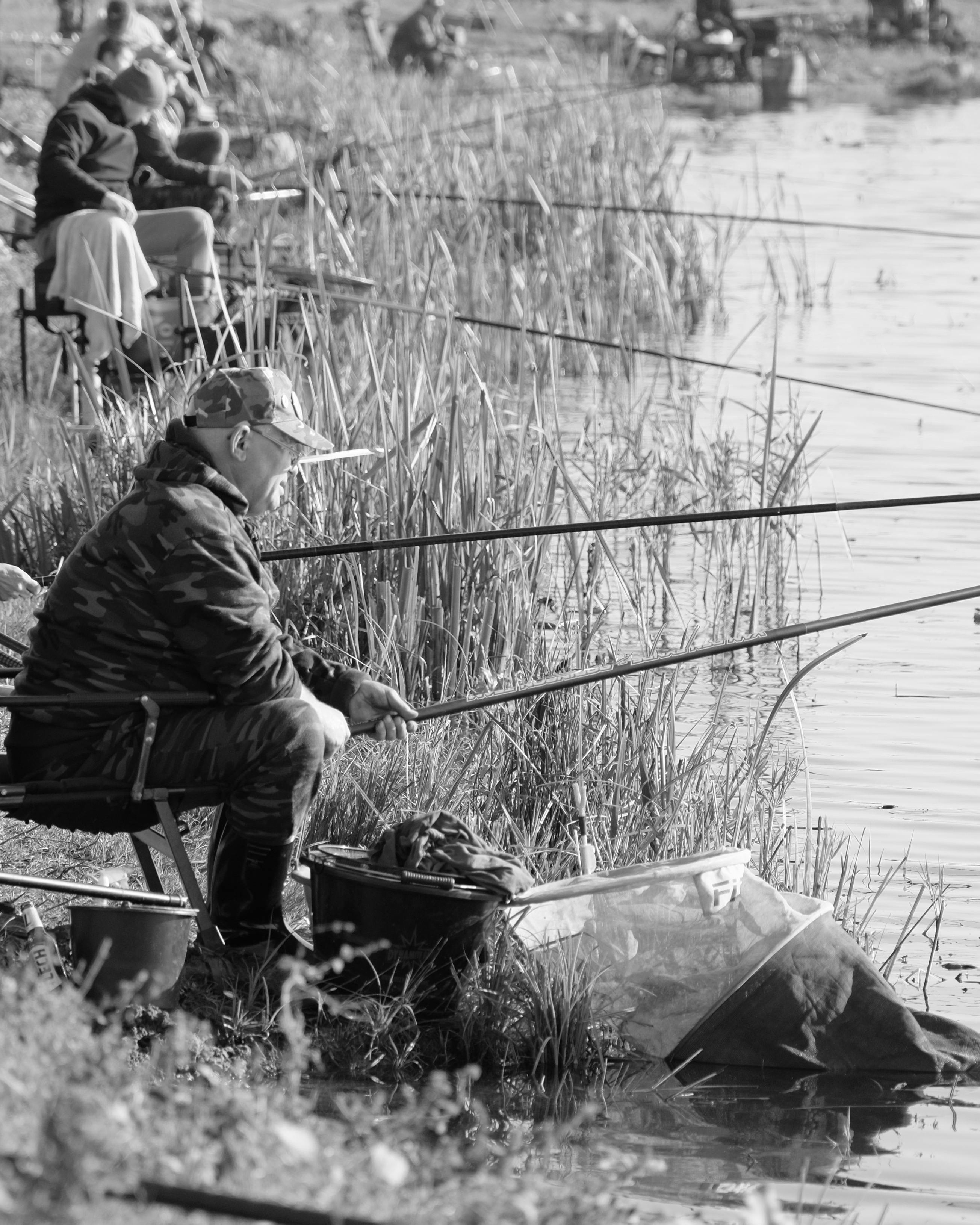 Anglers Fishing Along Lakeshore