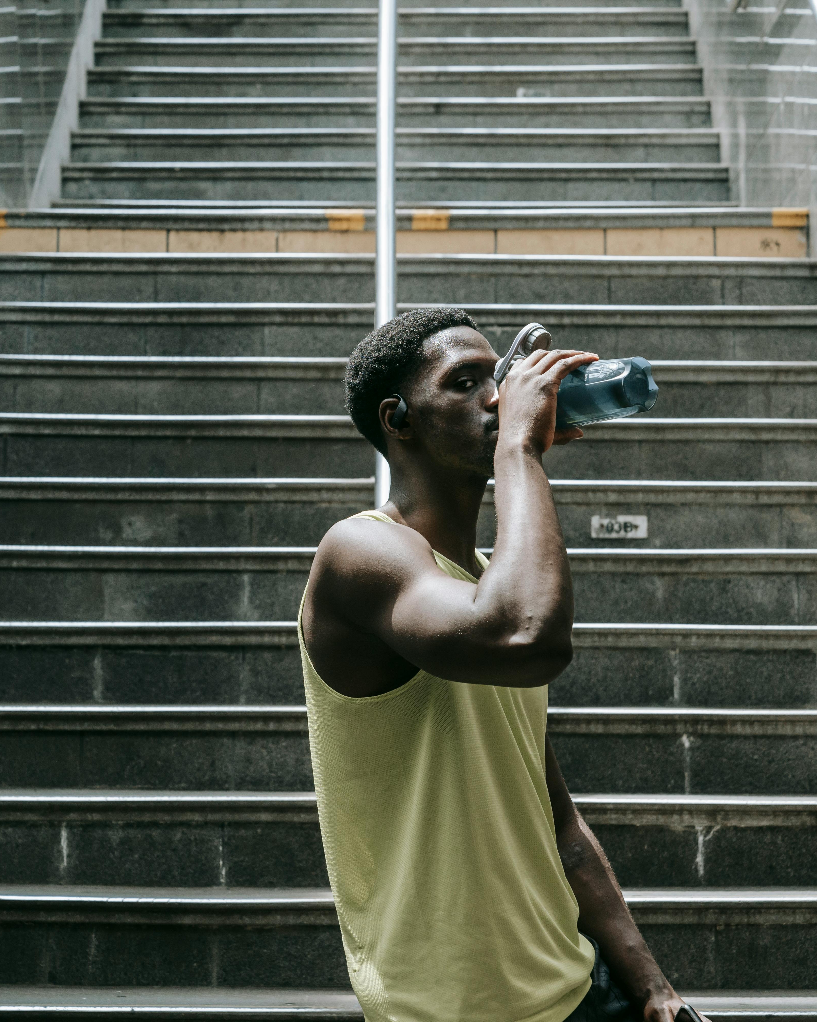 Man Drinking Water After Urban Workout