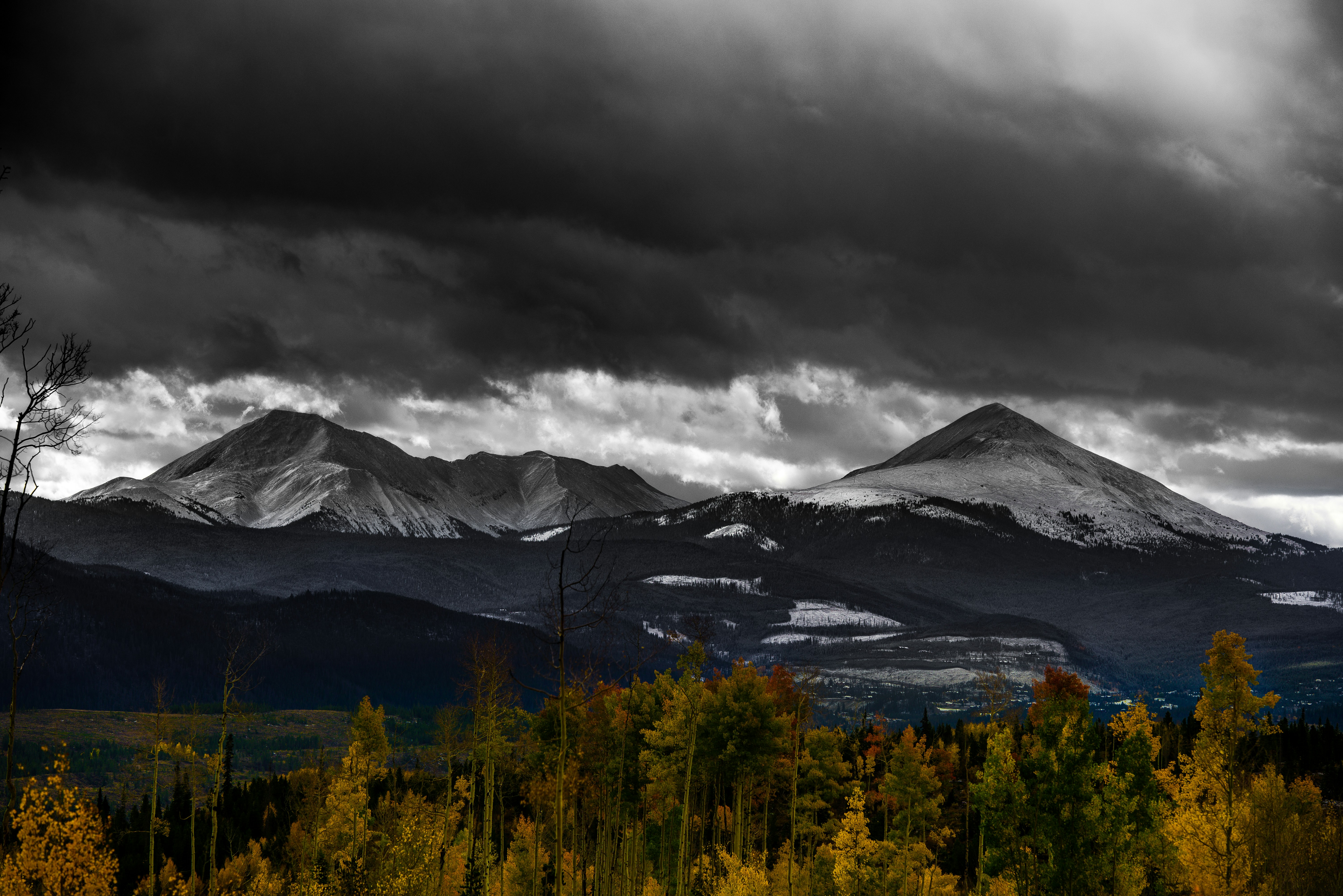 Storm Clouds Over Snowy Autumn Mountains