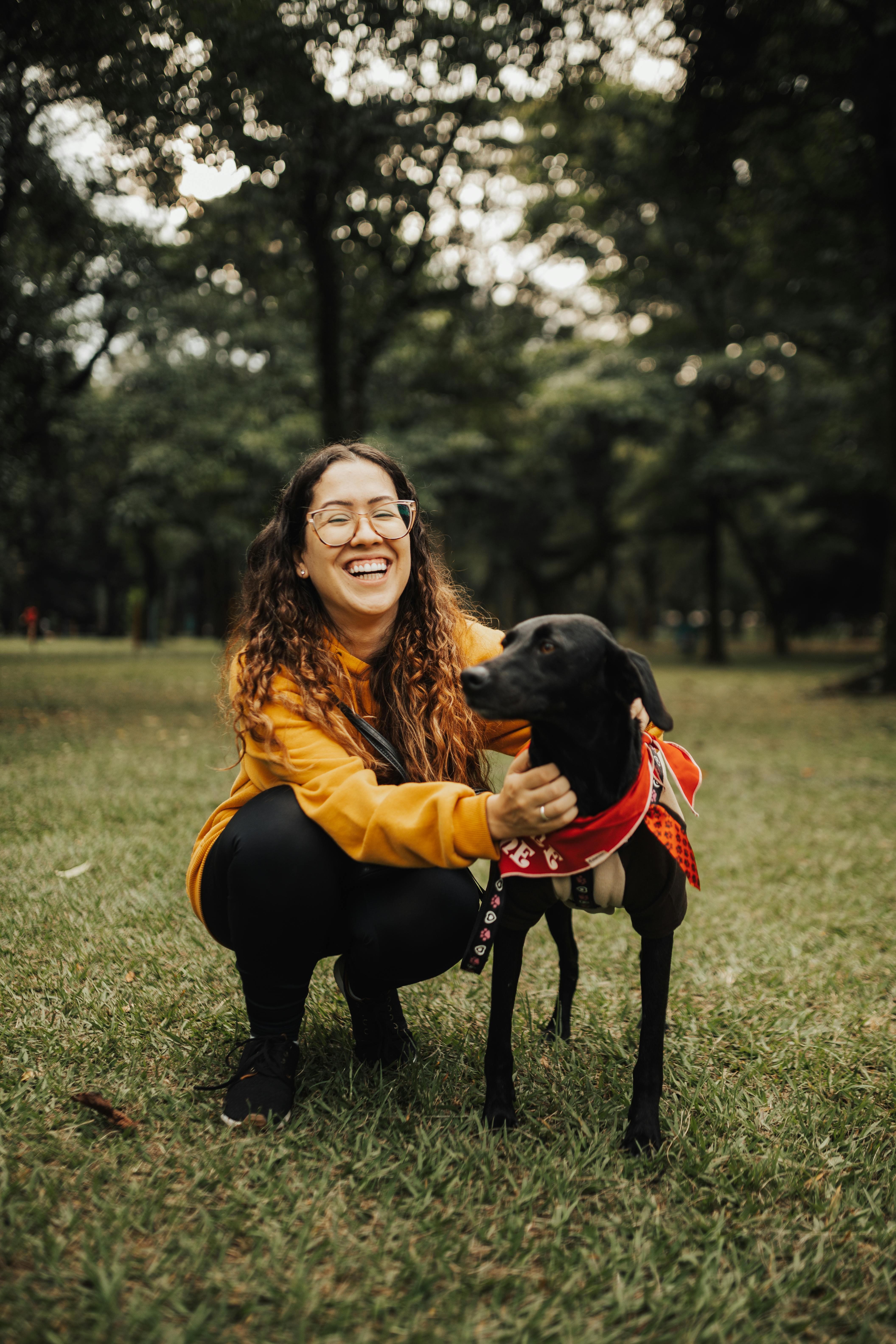 Smiling Woman and Black Dog in Park