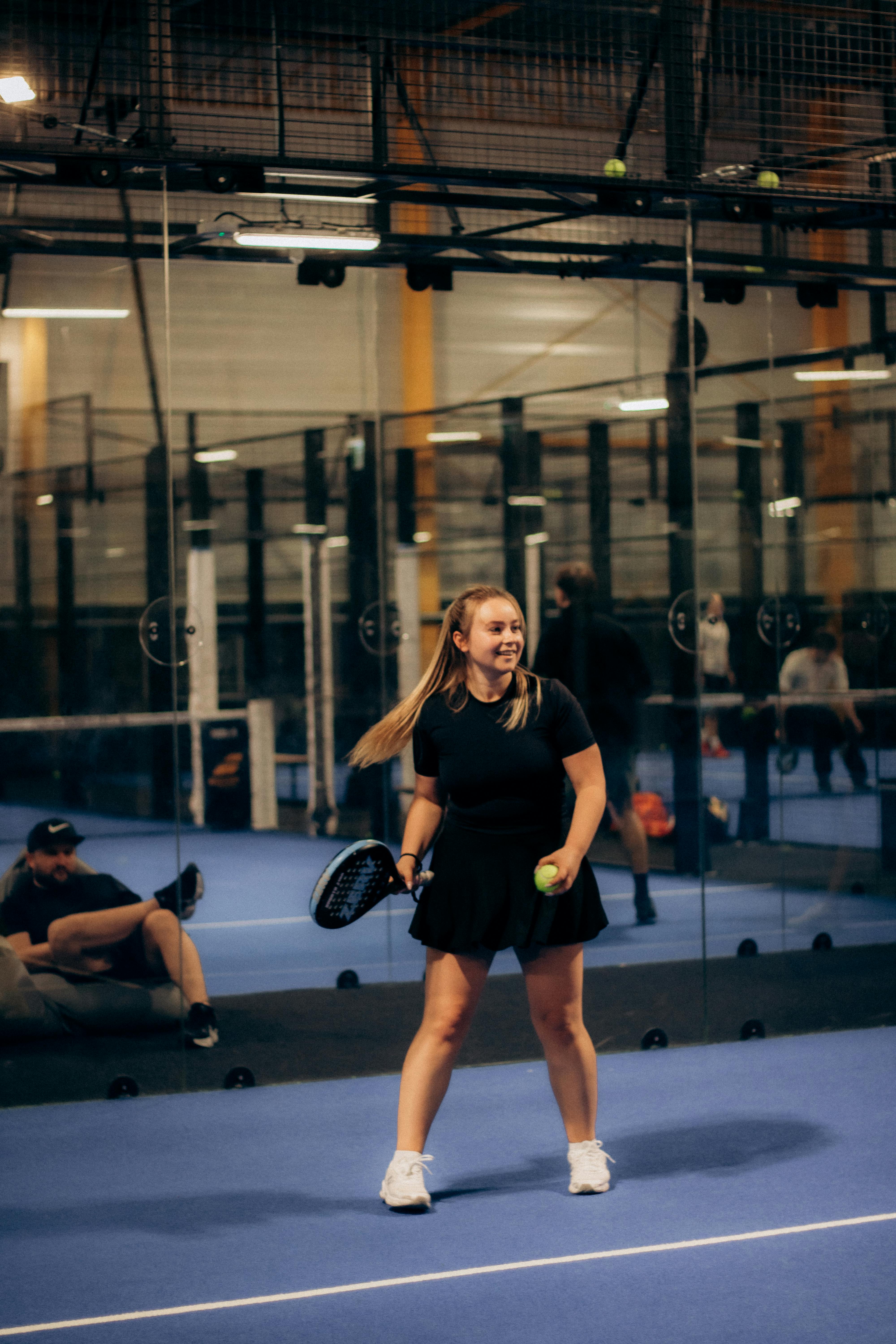 Woman Playing Padel on Indoor Court