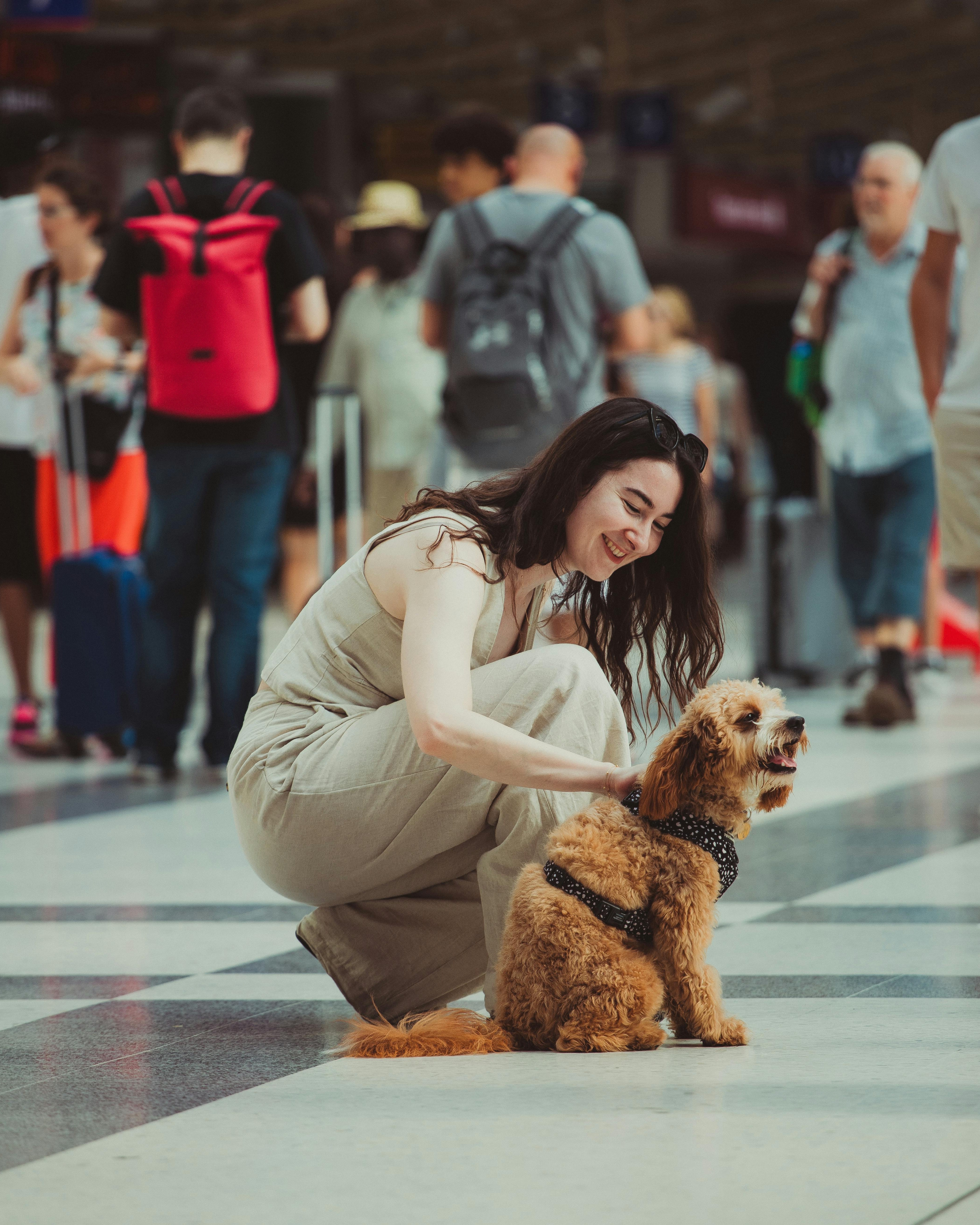 Woman Petting Dog in Train Station